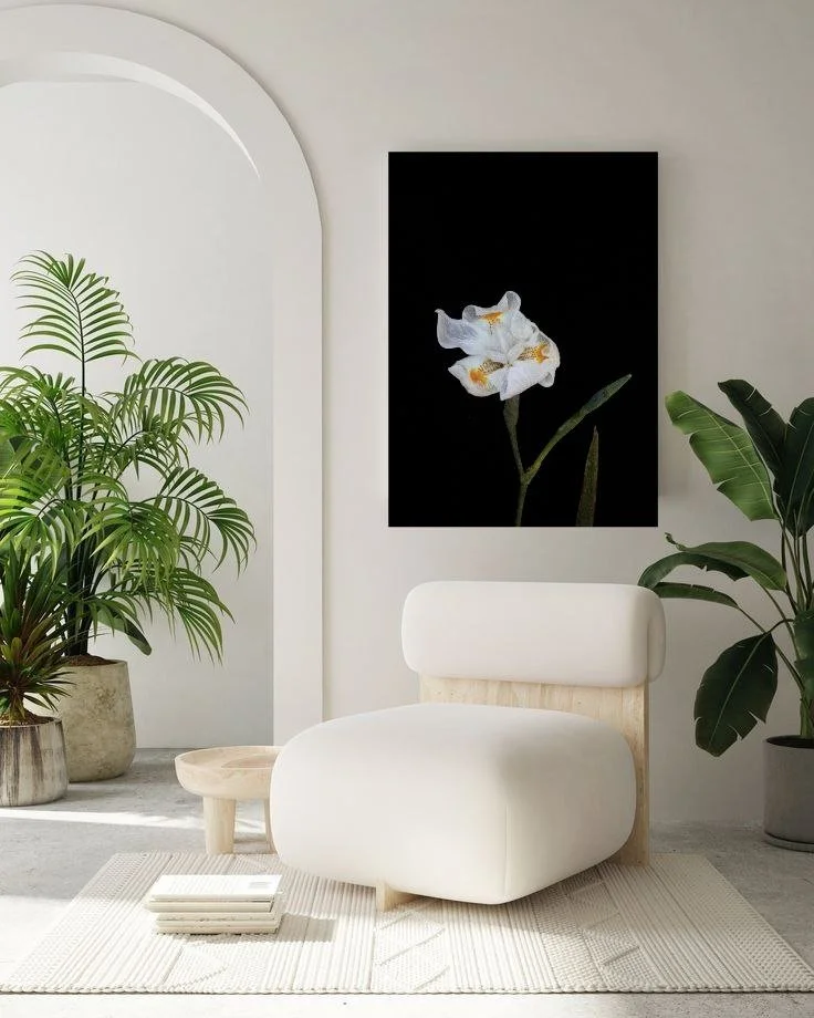 Dark floral artwork in minimal modern interior creating calm atmosphere