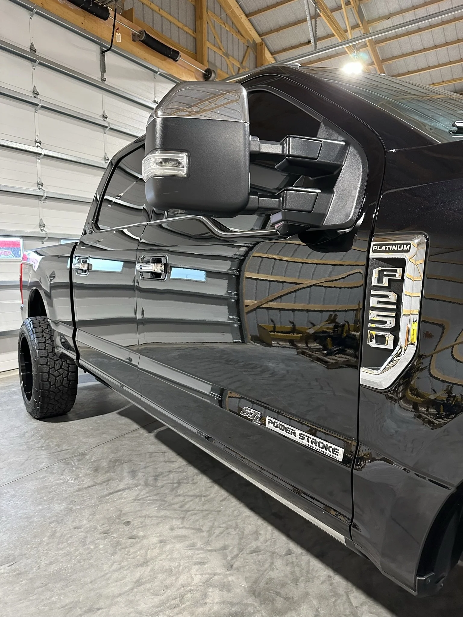 side of clean black truck after premium detailing