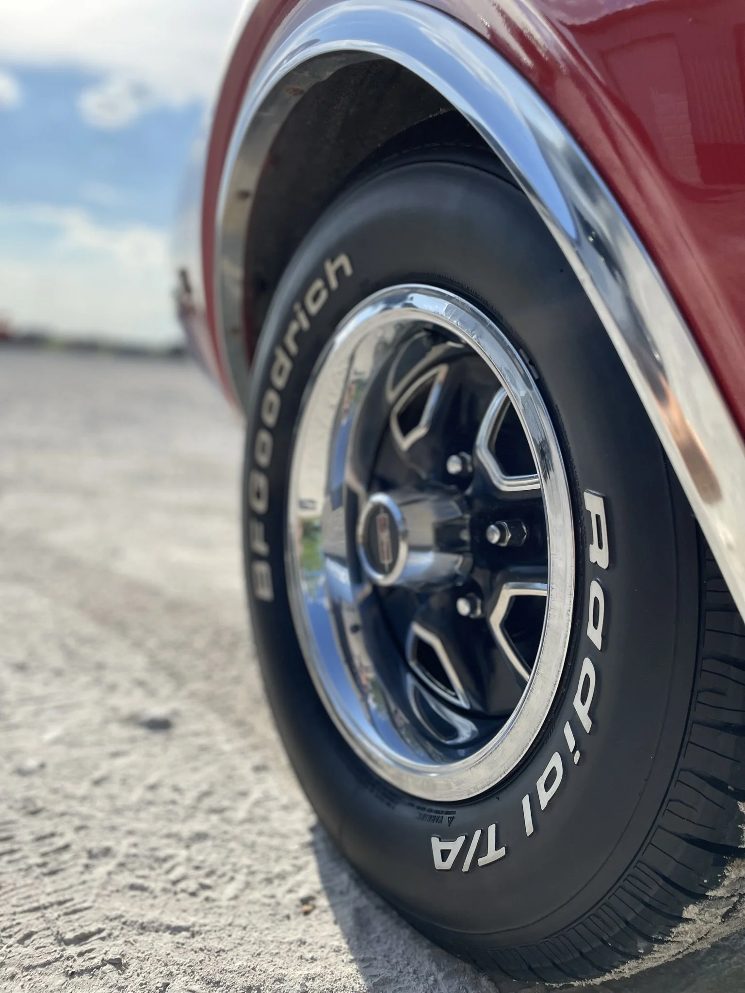 shiny rim and tire of clean red sports car