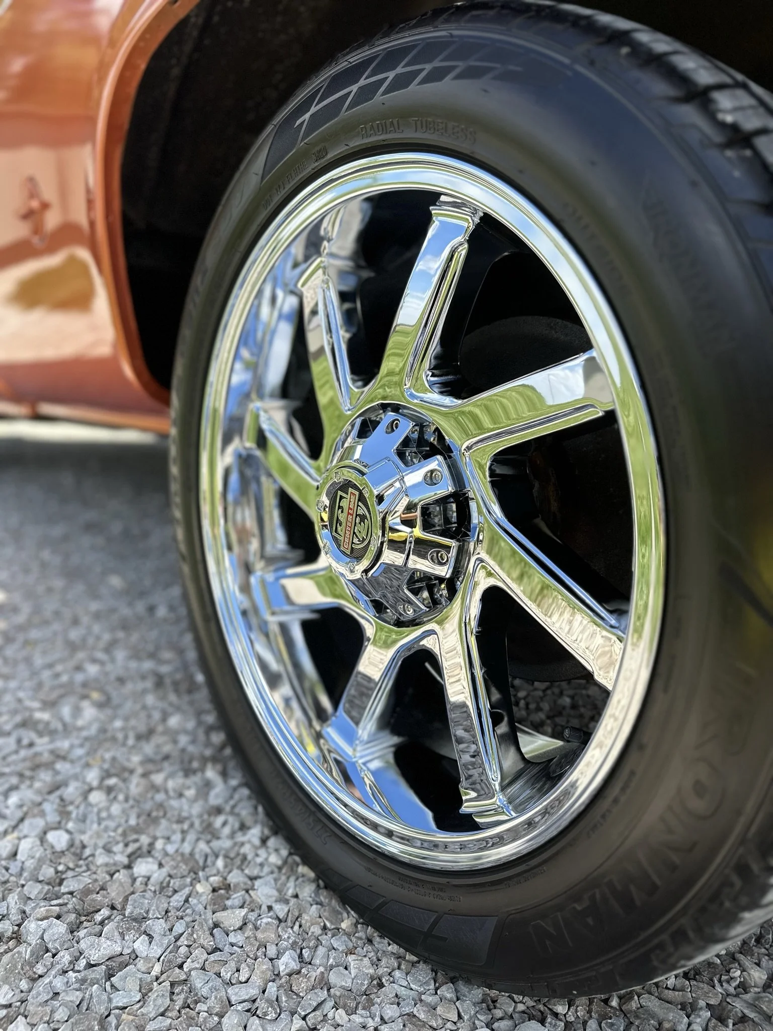 shiny rim and clean wheel of red orange truck