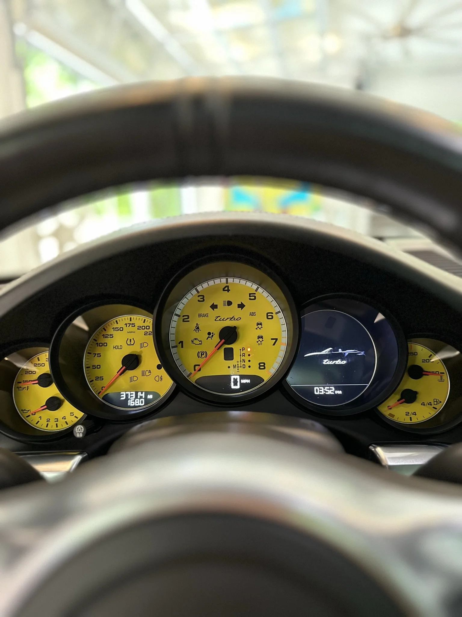 steering wheel with speedometer in background