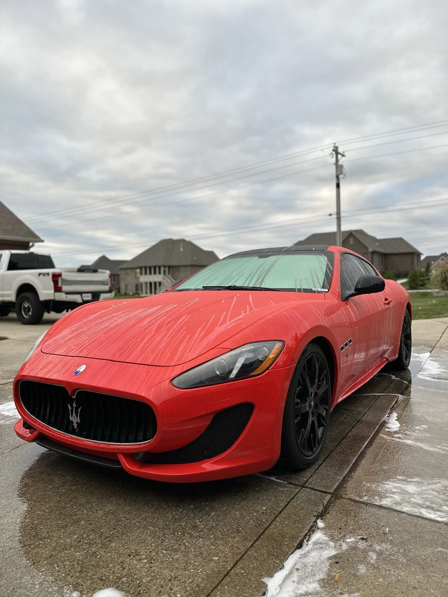dirty red sports car before