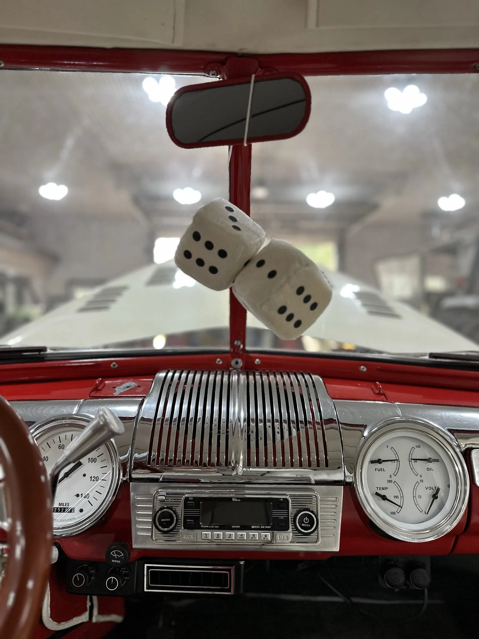 dice hanging from mirror inside clean car dashboard