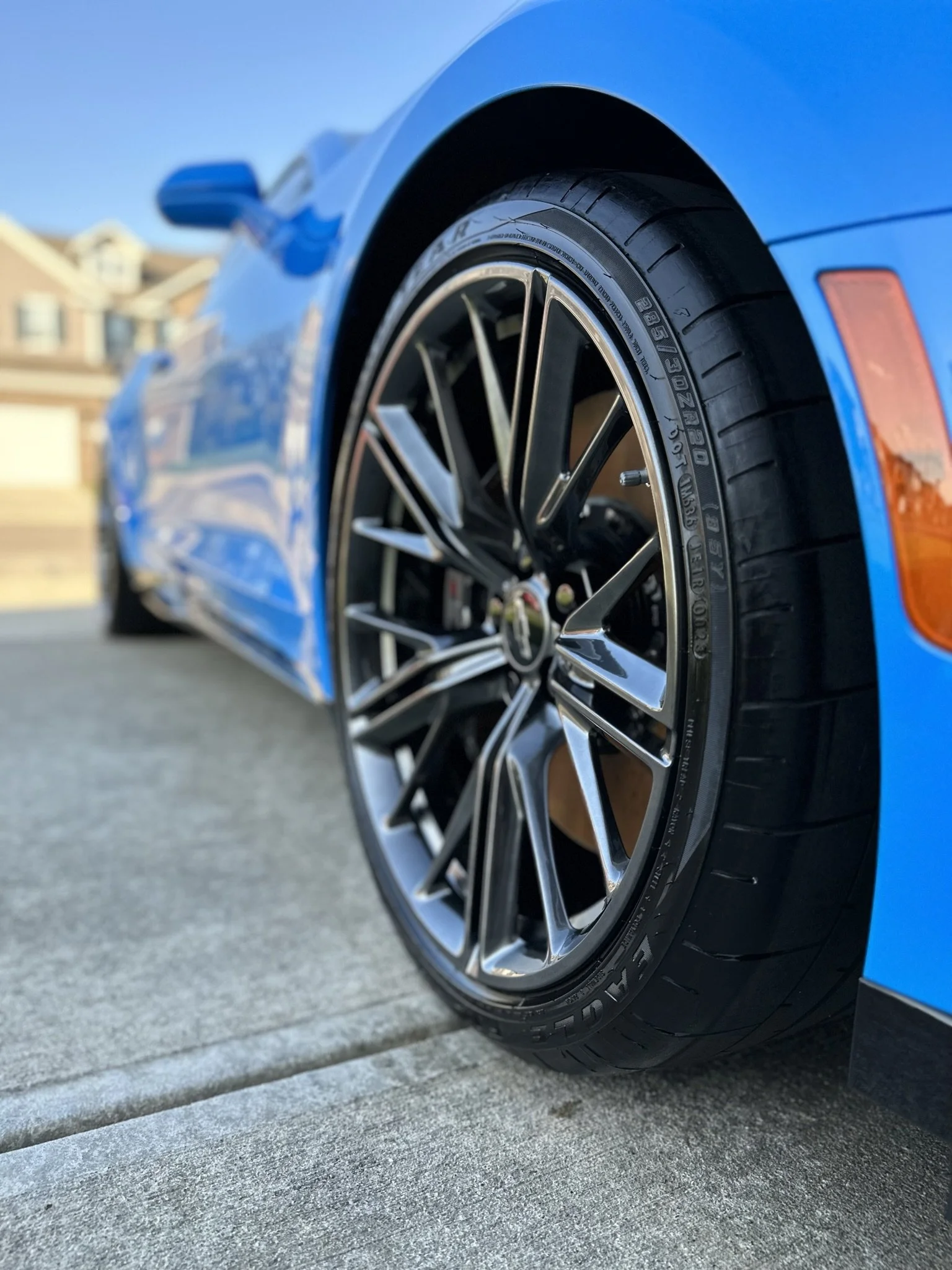 clean tire and rim on blue muscle car
