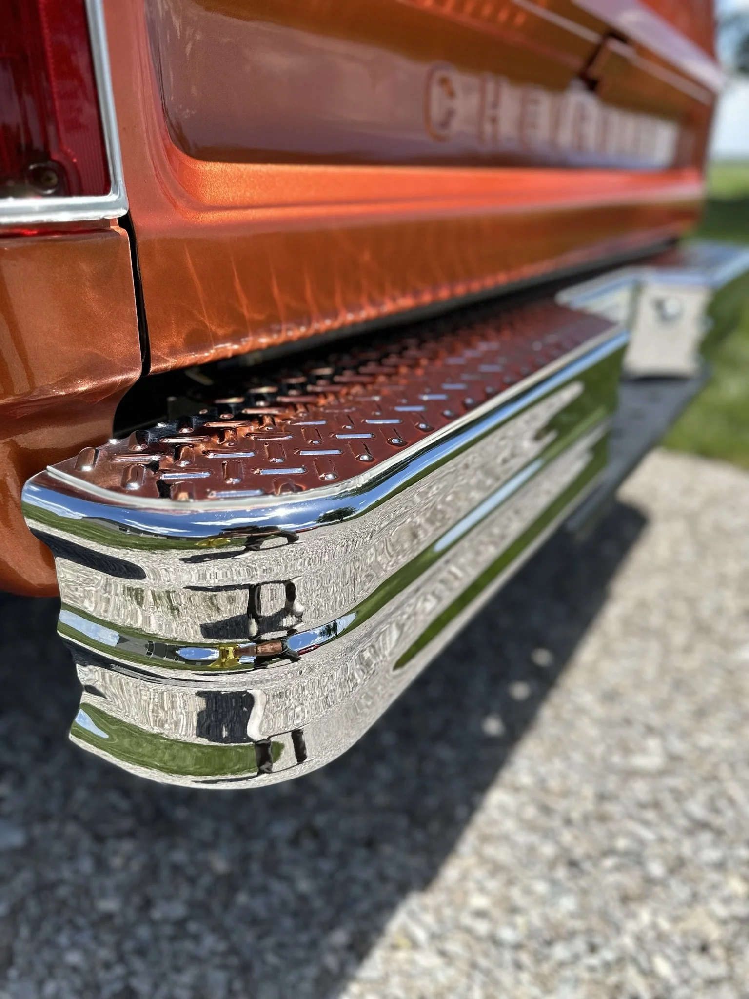 shiny tailgate of red orange truck