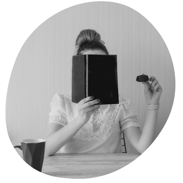 Woman hiding behind a book