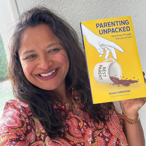 Rima Elahi-Syed holding the book Parenting Unpacked