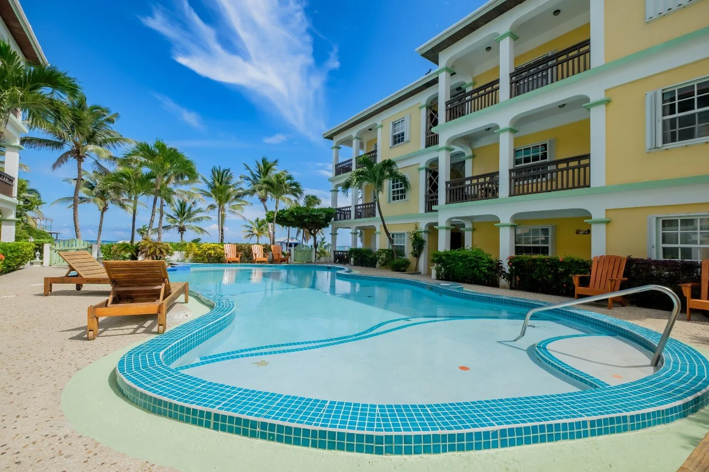 At 2,197 square feet, the Oasis Del Caribe penthouse is genuinely large for a beachfront condo on Ambergris Caye. Most units at this address are considerably smaller. This one has three bedrooms, three full bathrooms, and then a private upstairs loft