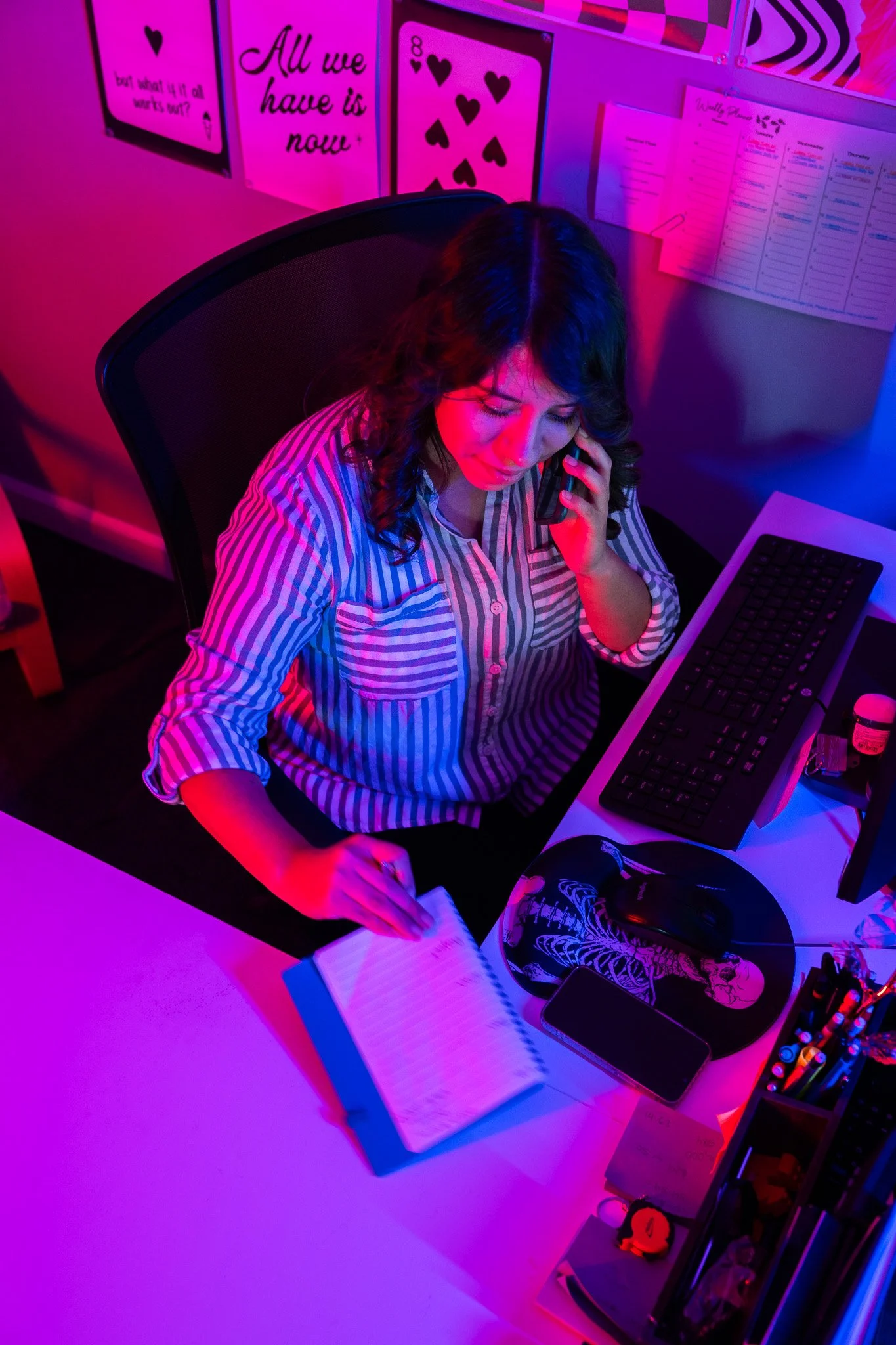 Margarita, Sales Account Manager at Don't Lose Hope Screen Print, takes notes while on the phone with a customer about a screen printing order.
