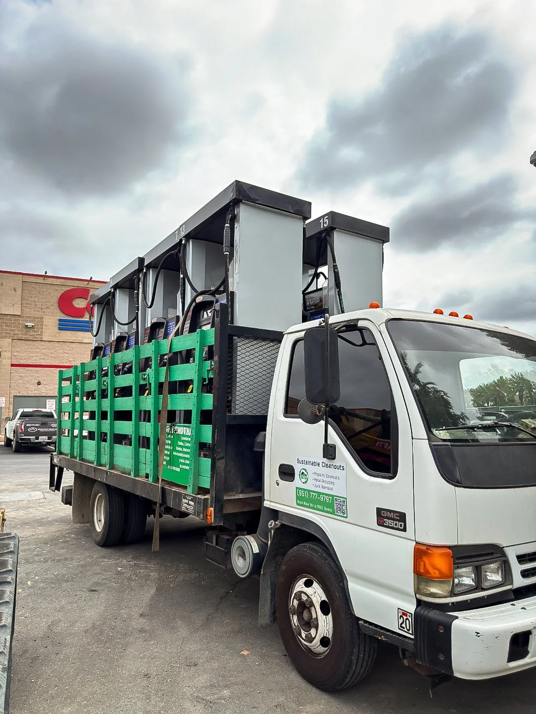 Sustainable Cleanouts truck loaded for commercial hauling outside a retail property.