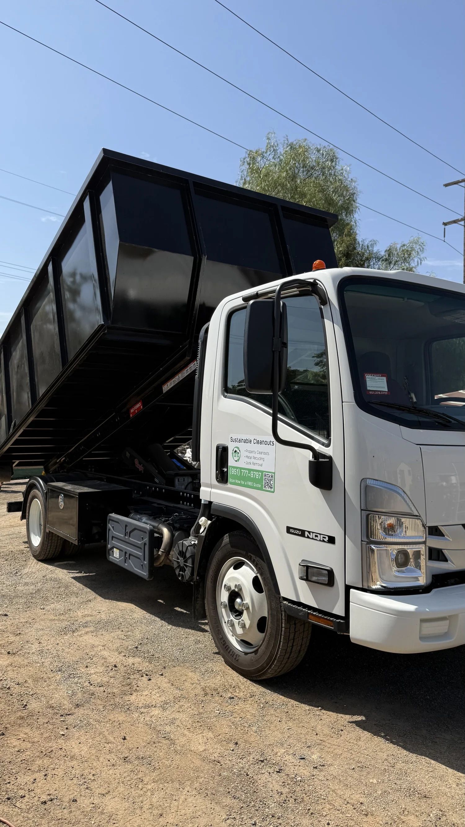 Sustainable Cleanouts roll-off truck equipped for large property cleanouts