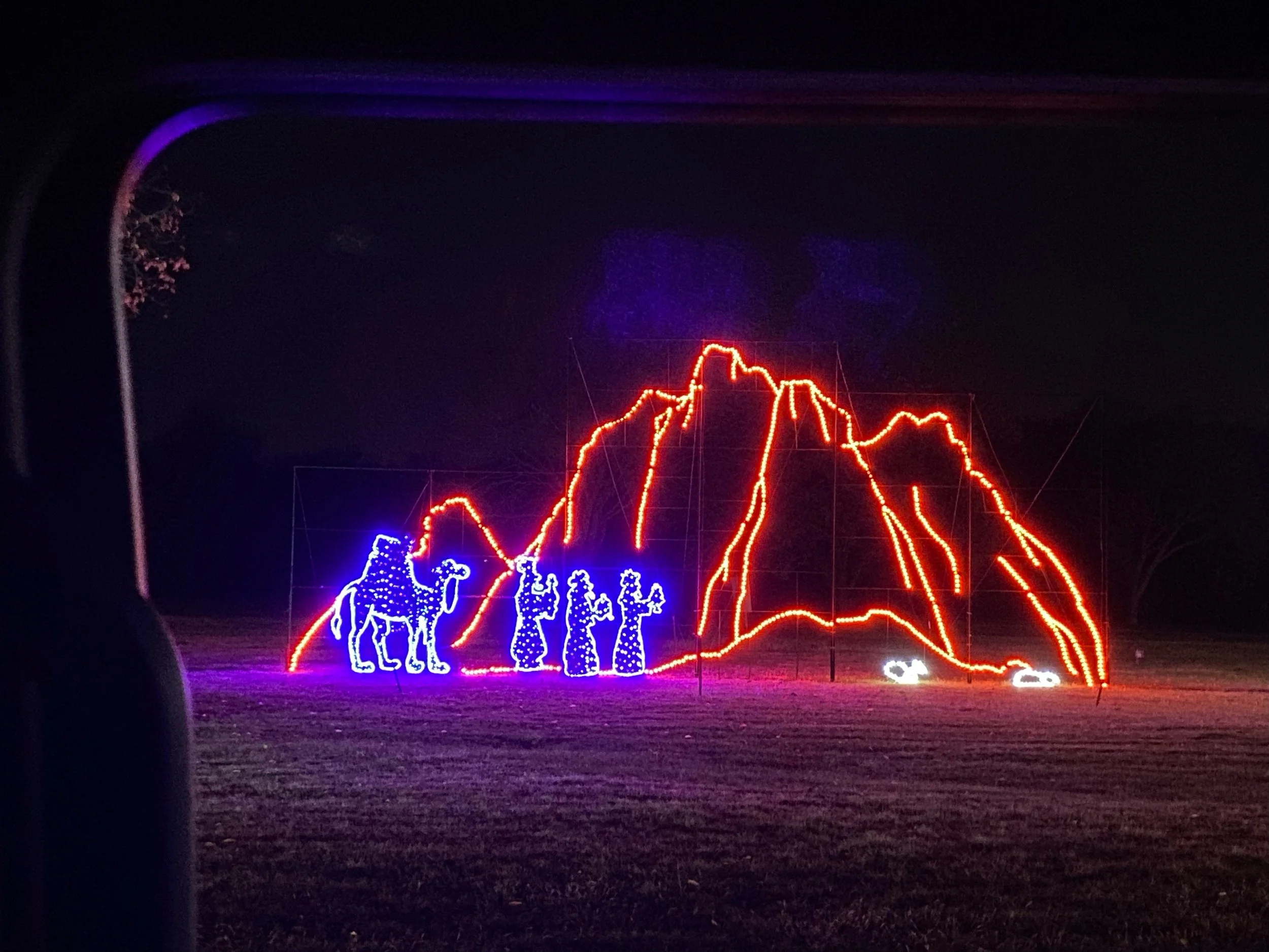Christmas lights display depicting a mountain, a camel, and three wise men.