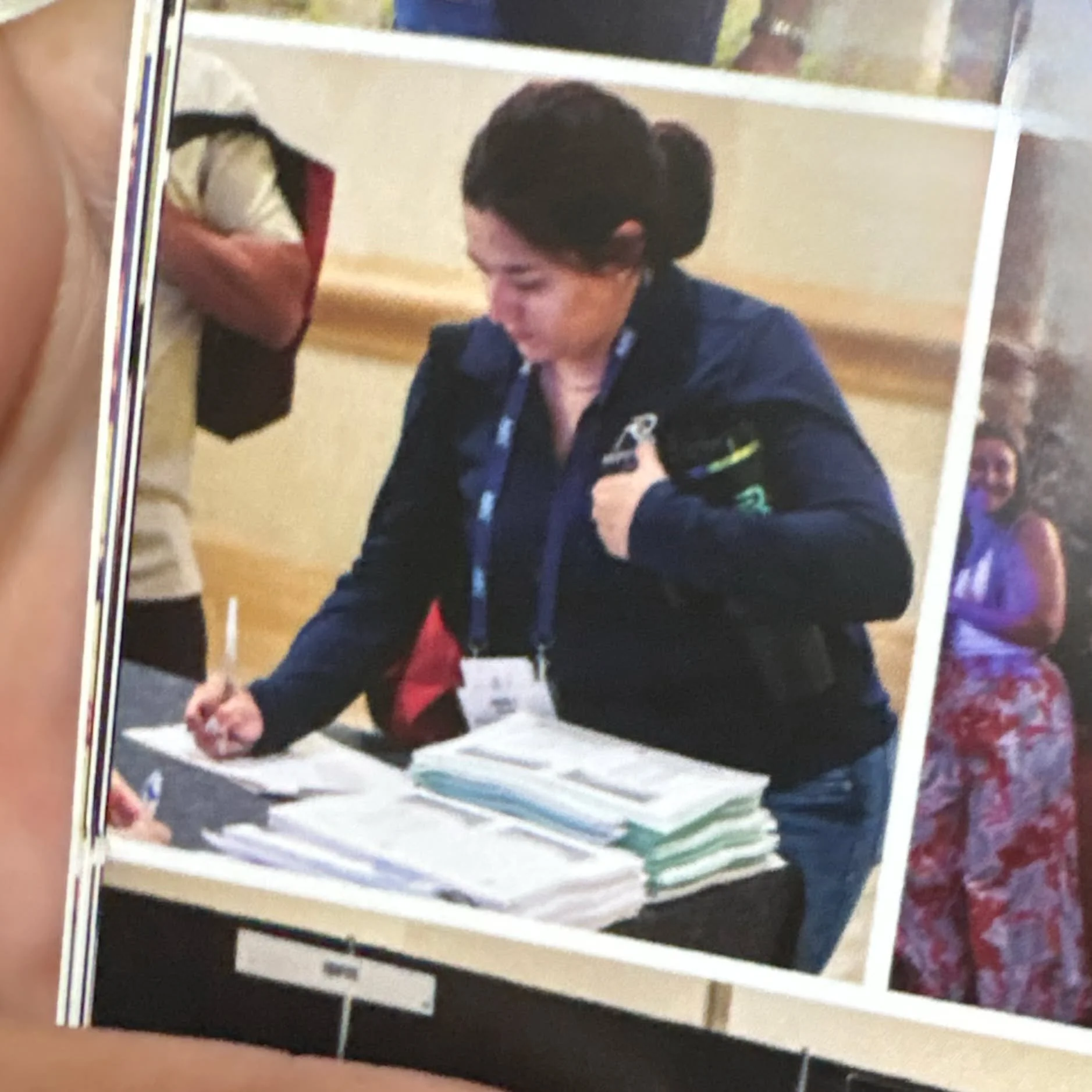 What could Anali be holding on to so tight? A, B, or C
A. Her pen
B. Her badge
C. (Fill in the blank)