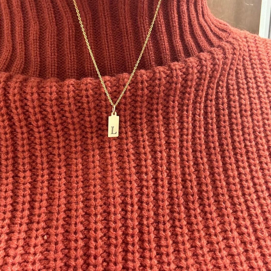 Initial Tag Necklace against sweater.jpg
