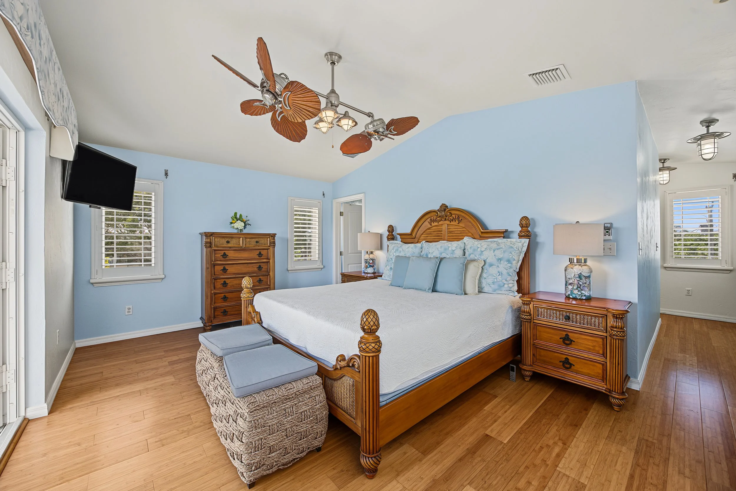 Spacious primary bedroom with tropical-style furnishings in a Key Largo, Florida home