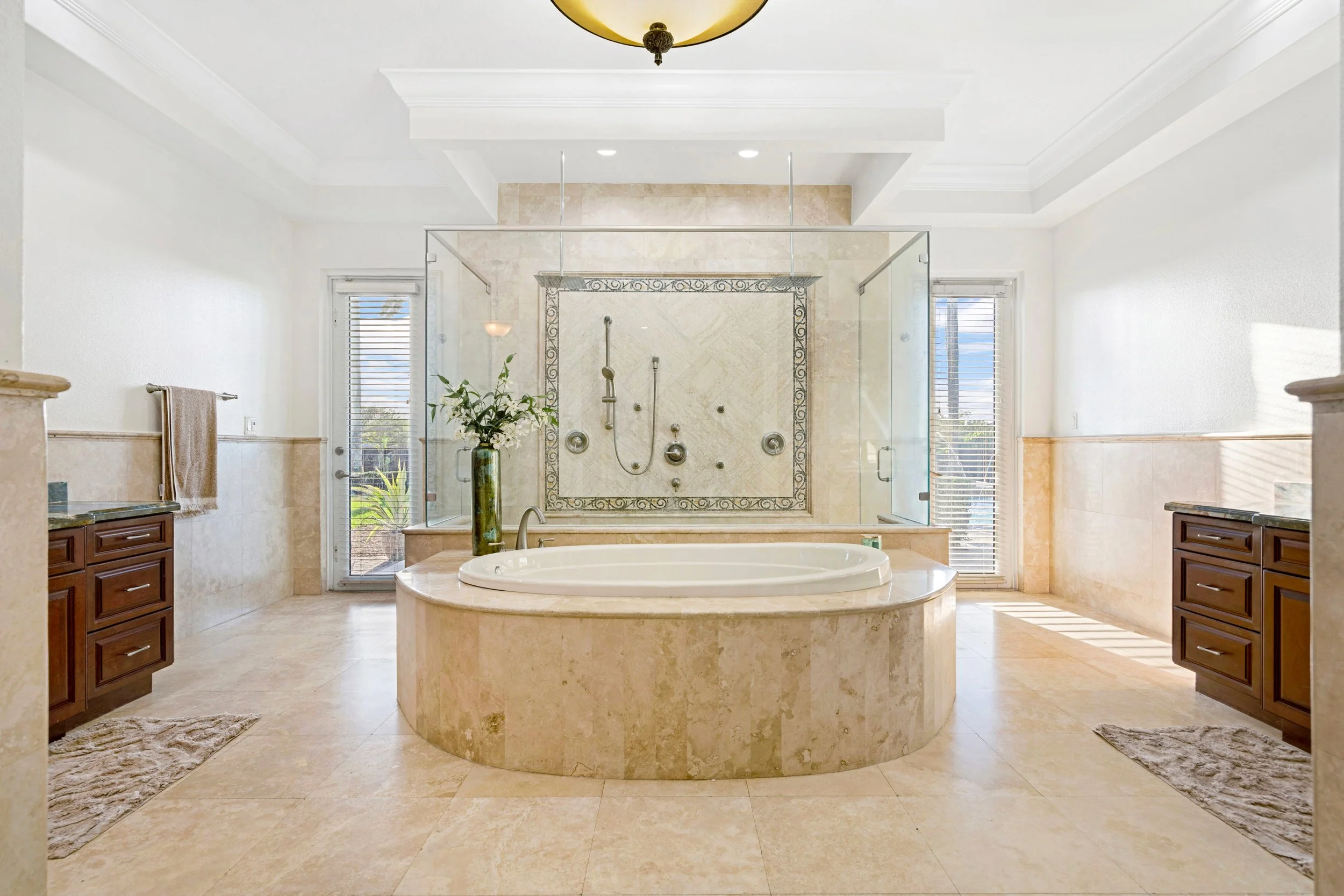 Luxury primary bathroom with soaking tub and large glass shower in a Homestead and Redland home.