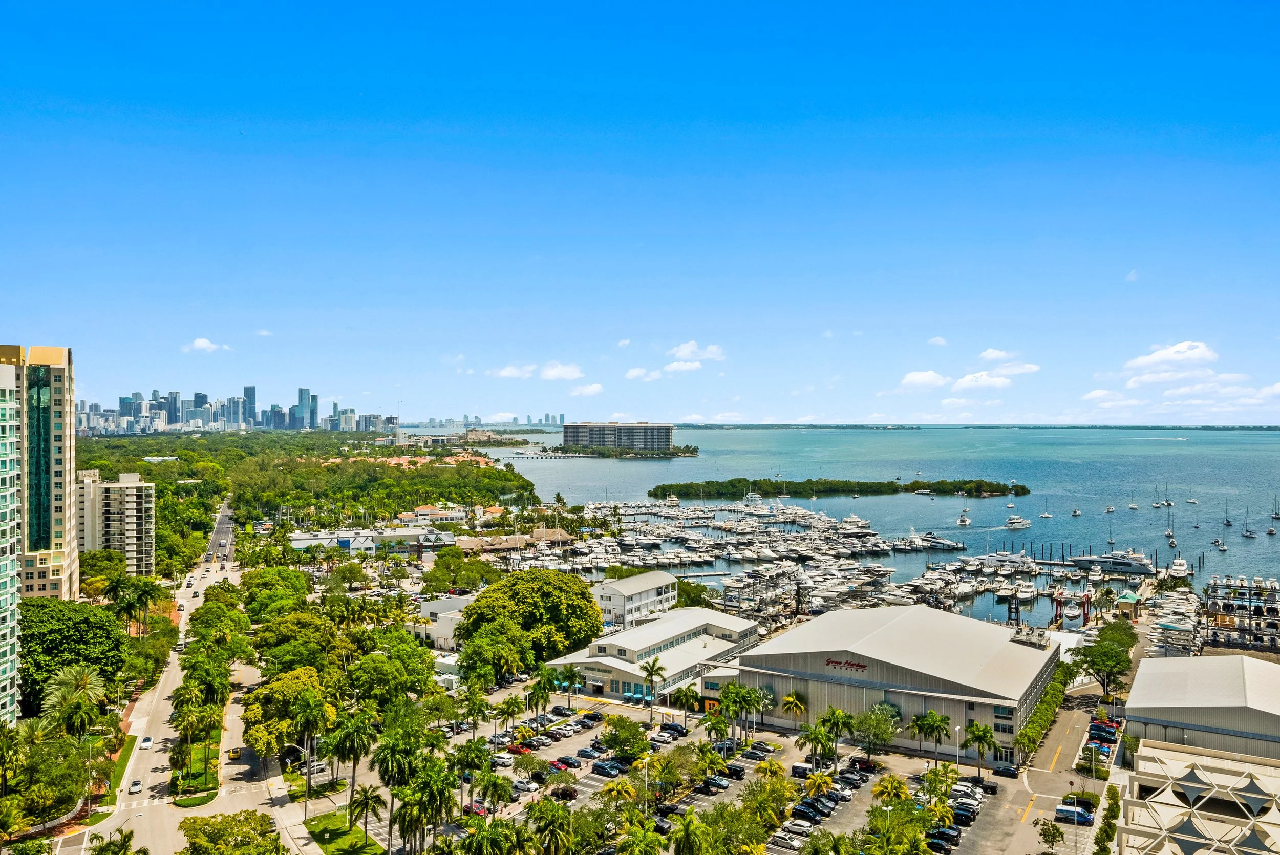 Coconut Grove waterfront and marinas overlooking Biscayne Bay with the Miami skyline in the distance.