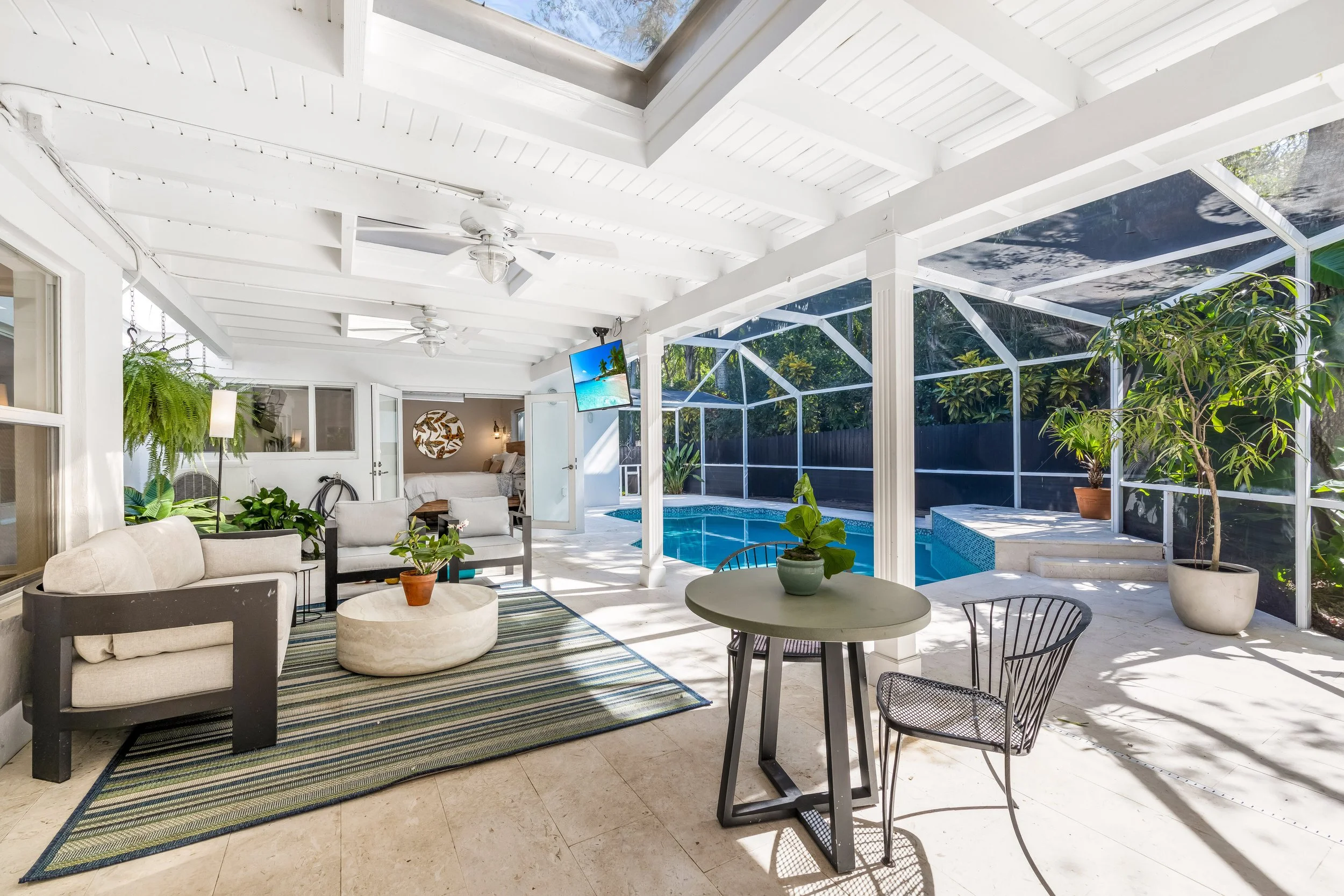 South Miami luxury home with screened pool, covered patio and outdoor living area.