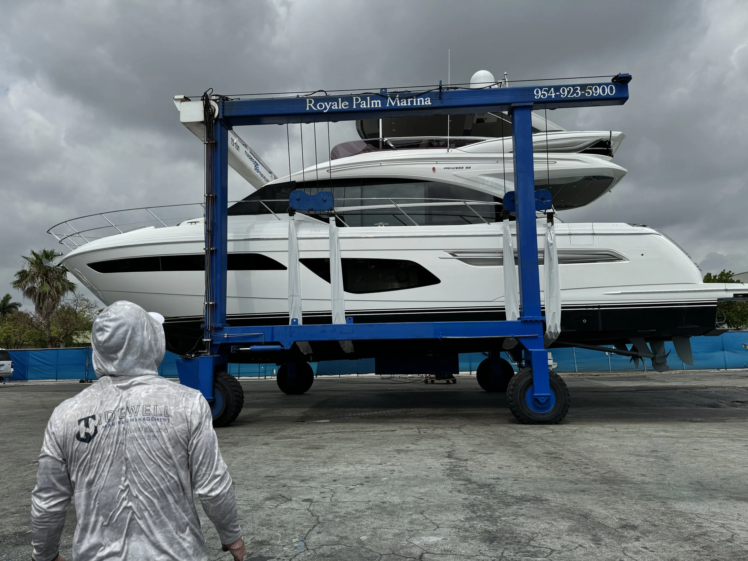 Boat being lifted at a marina for maintenance and inspection