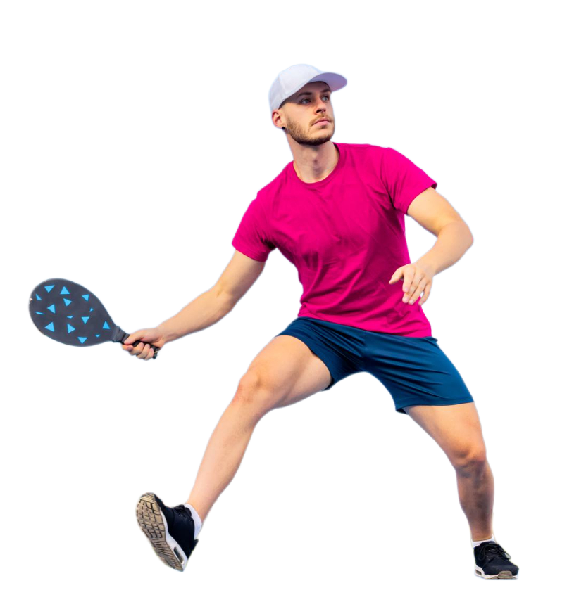 A young man wearing a pink t-shirt, navy shorts, and a white cap playing tennis with a black and blue tennis racket.