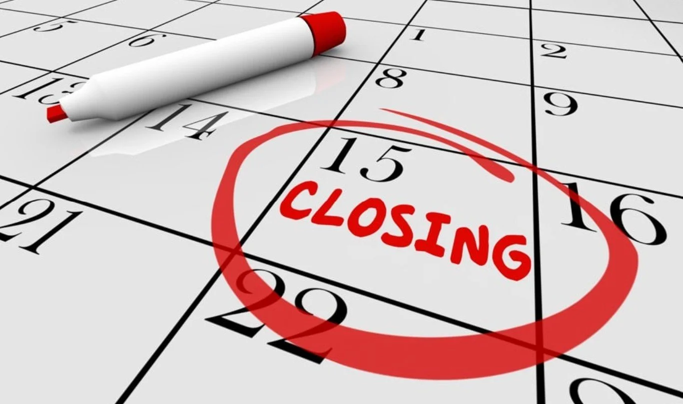 A bingo card with the word "CLOSING" written inside a red circle, and a white bingo marker pen resting on the card.