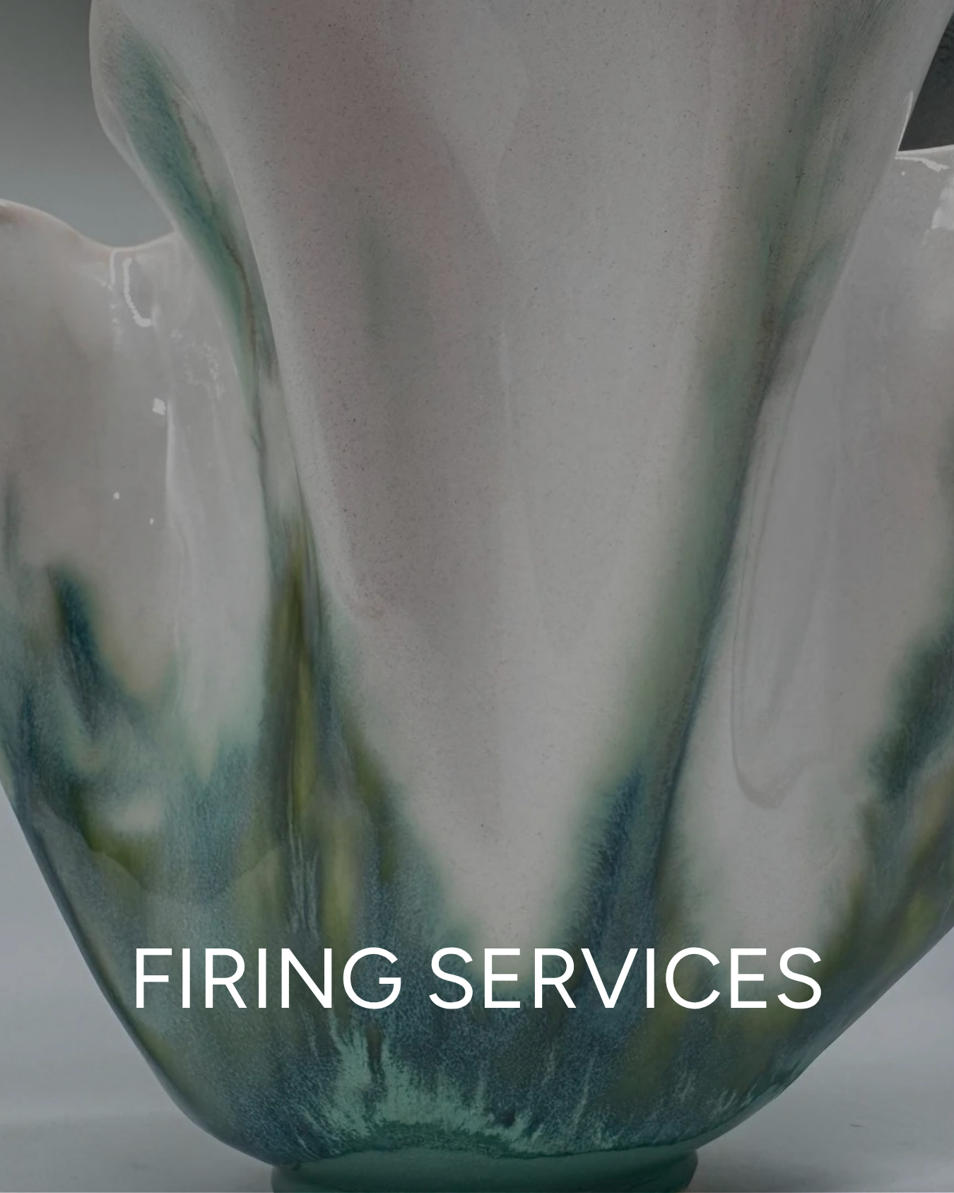 Close-up of a ceramic ruffle bowl with abstract green, blue, and white glaze, with the text 'Firing Services' at the bottom.