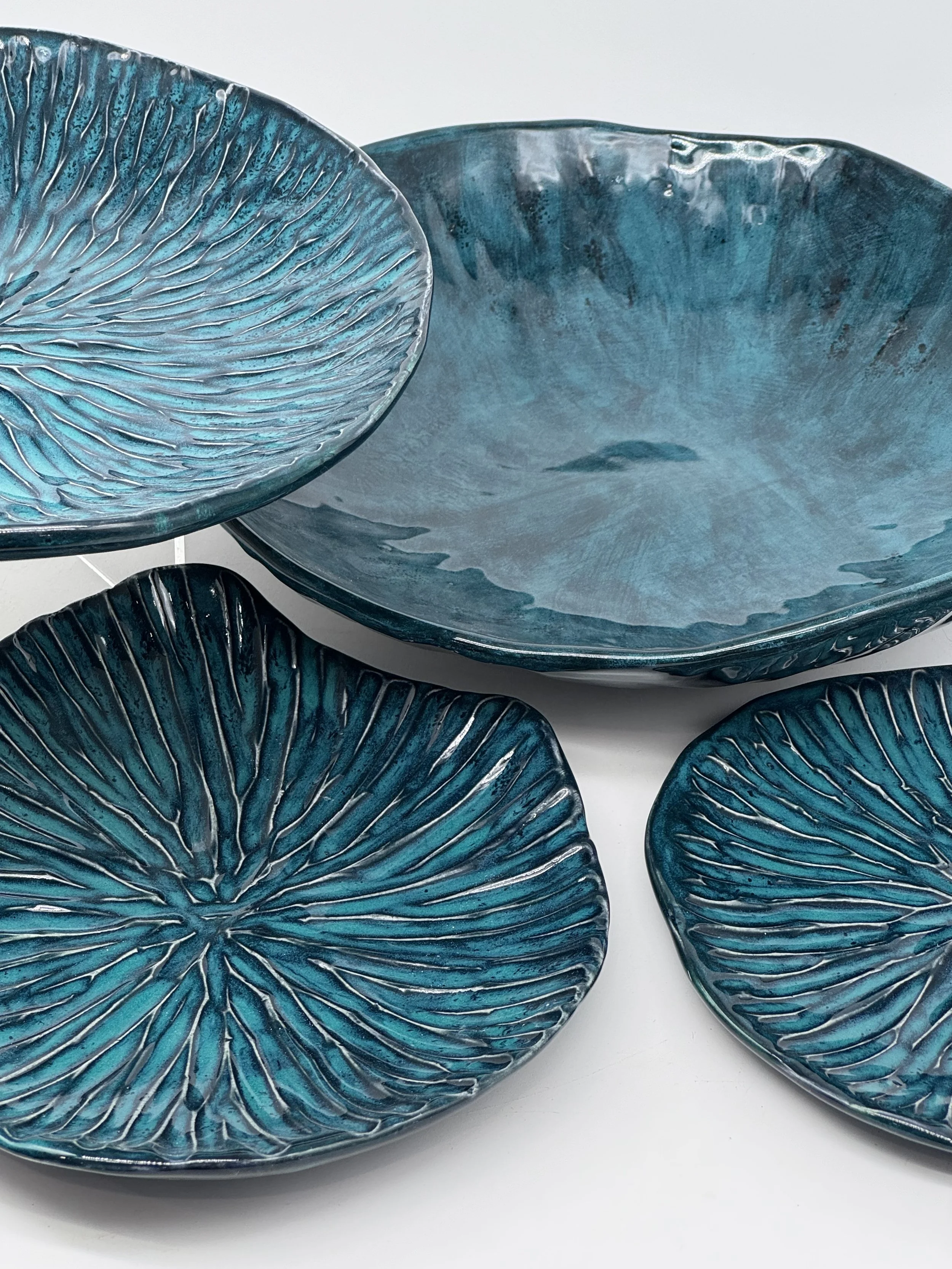 Stunning teal plates creating a beautiful lilly pad effect.   Texture highlights the black and teal glazes.
