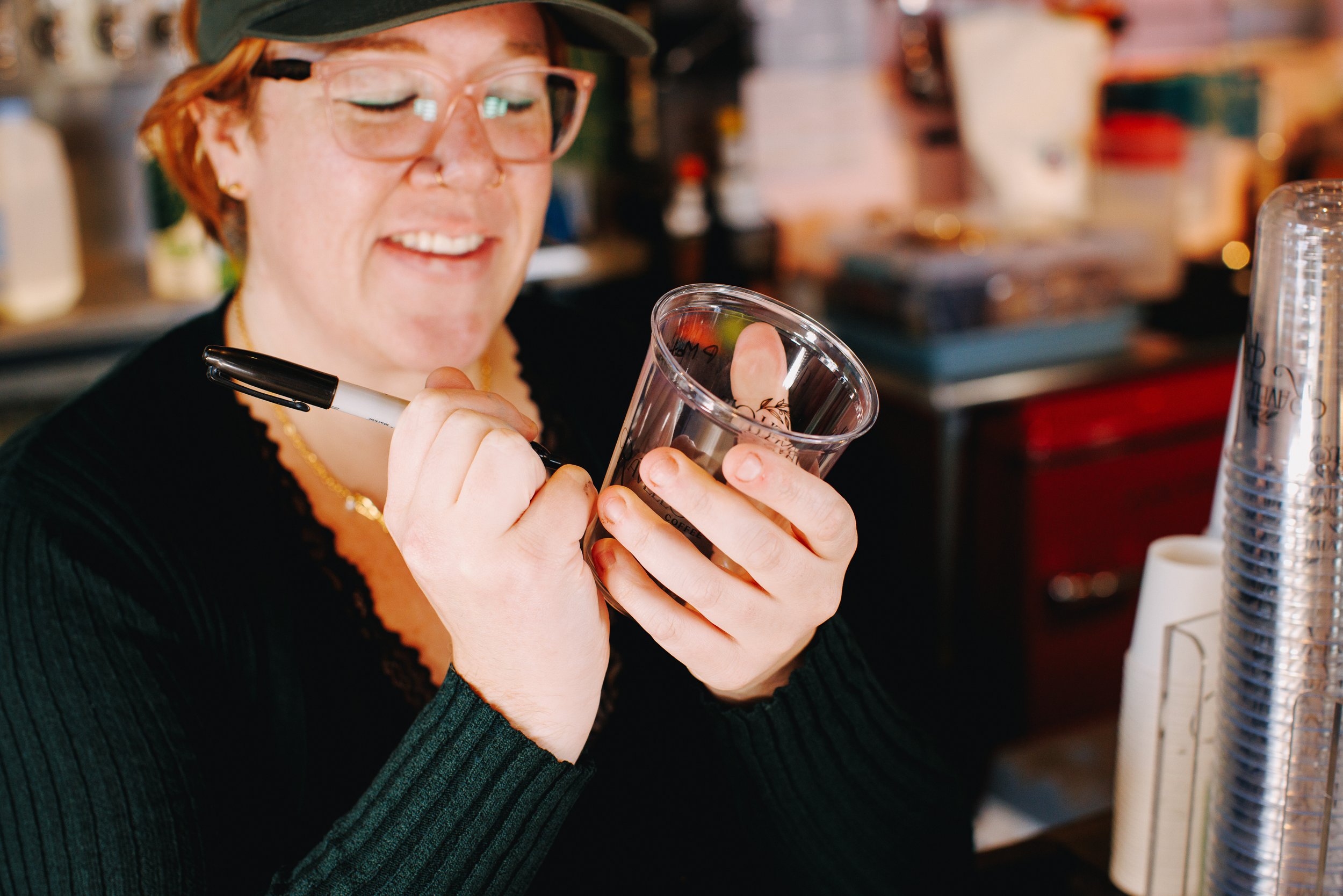 Barista writing name on Ravello's cup