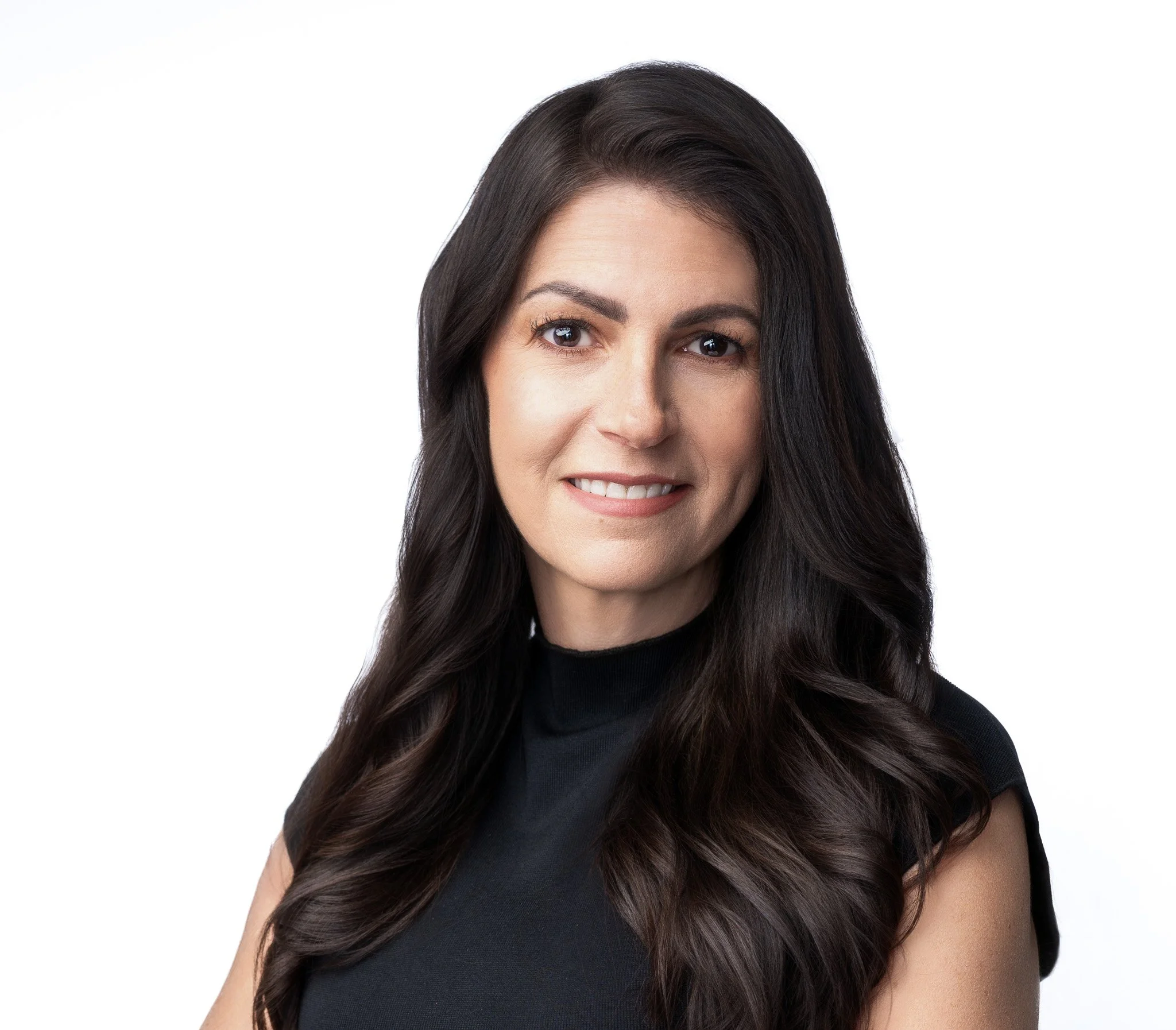 Headshot of woman psychologist with long dark hair with confident inviting smile