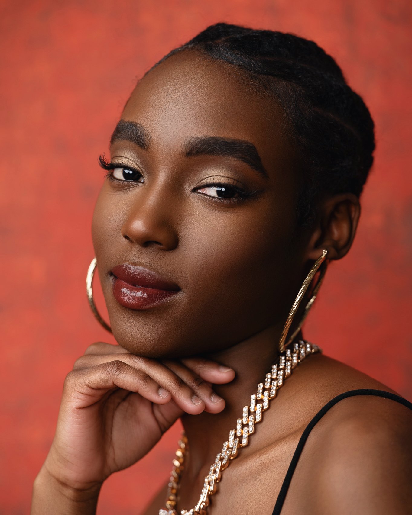 Glamour Beauty Portrait on Red Textured Backdrop
