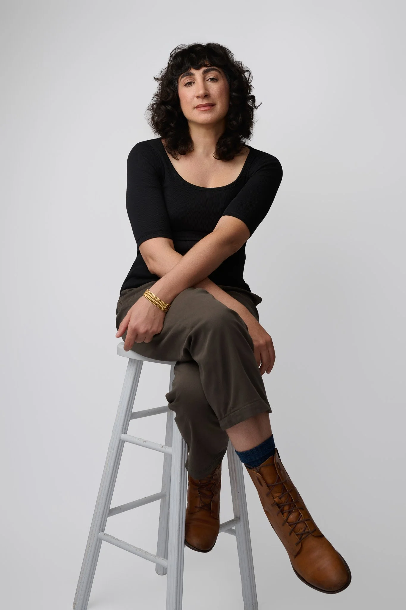 Modern Seated Portrait With Black Top and Boots