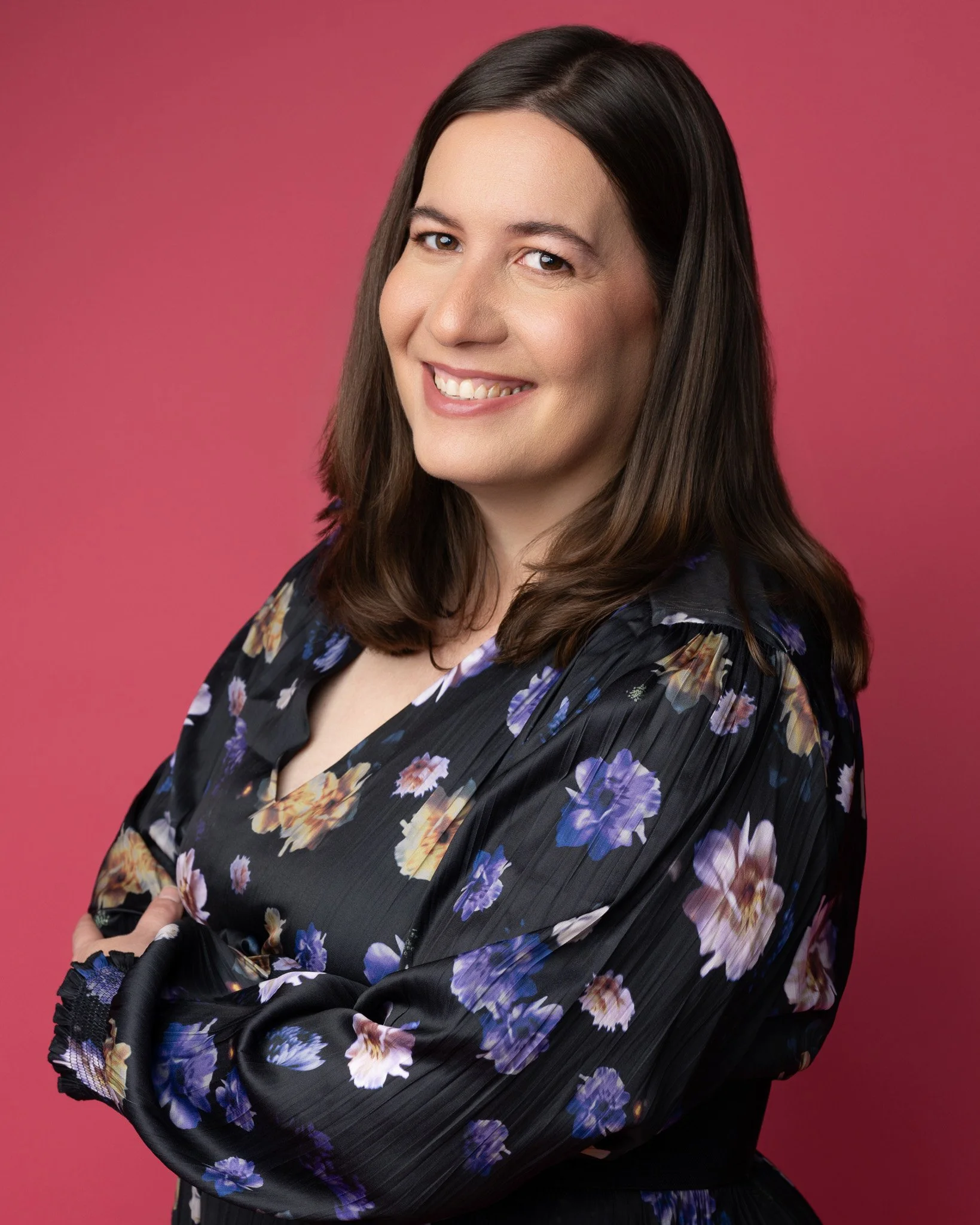  Modern Professional Headshot of Woman in Floral Dress on Pink Backgroun