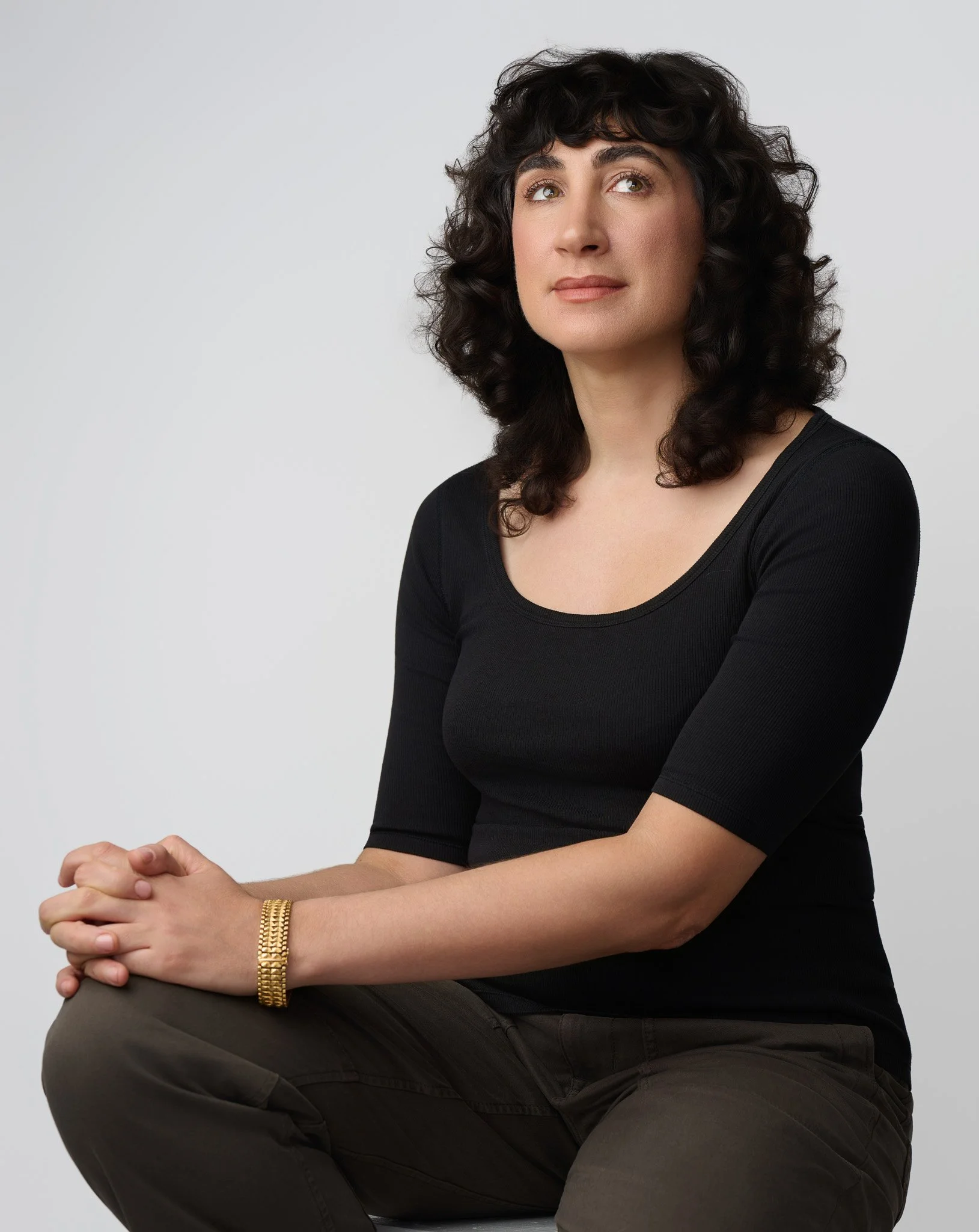Timeless Studio Portrait of Woman in Black Top With Natural Expression