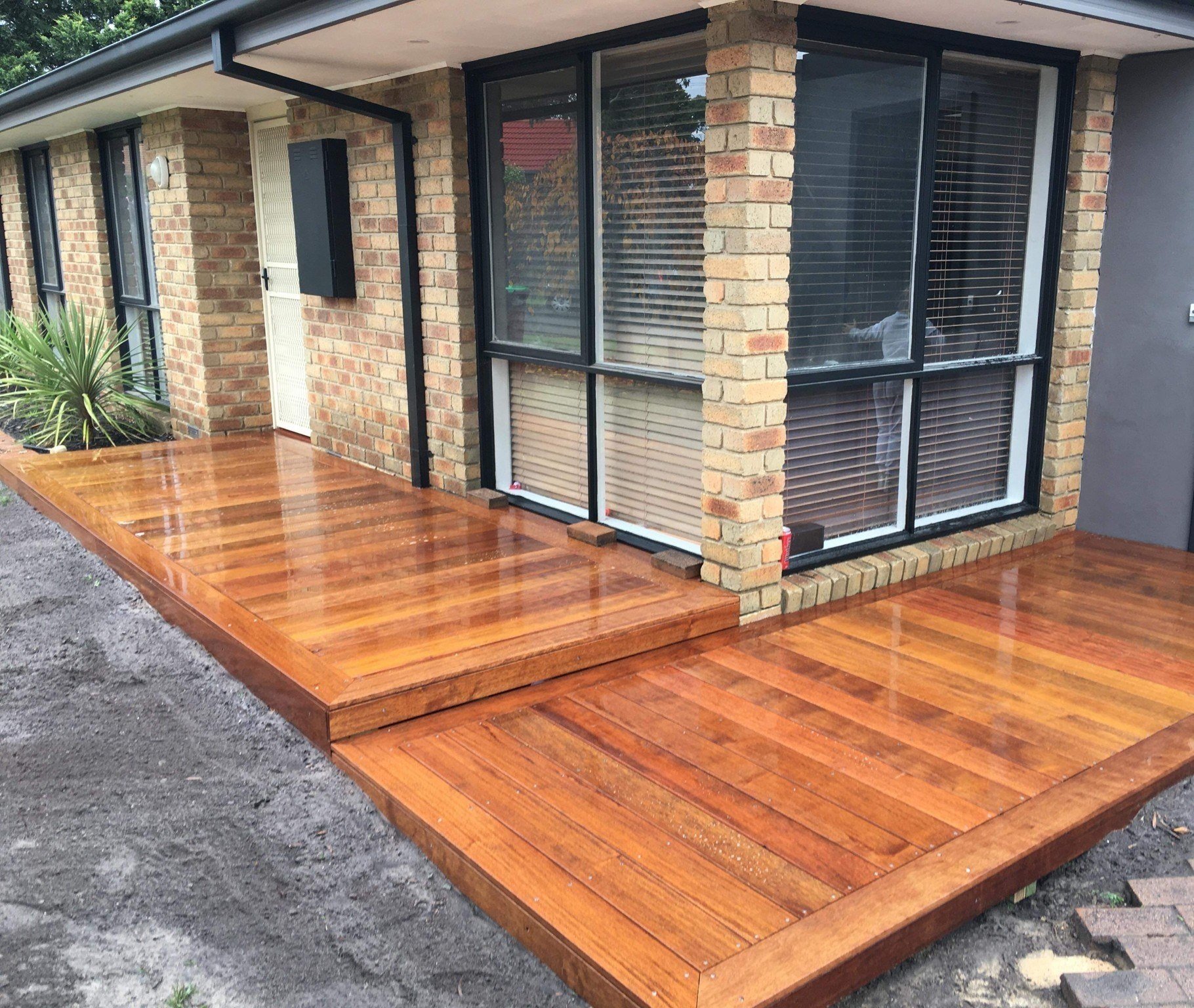 Merbau front deck around a brick home