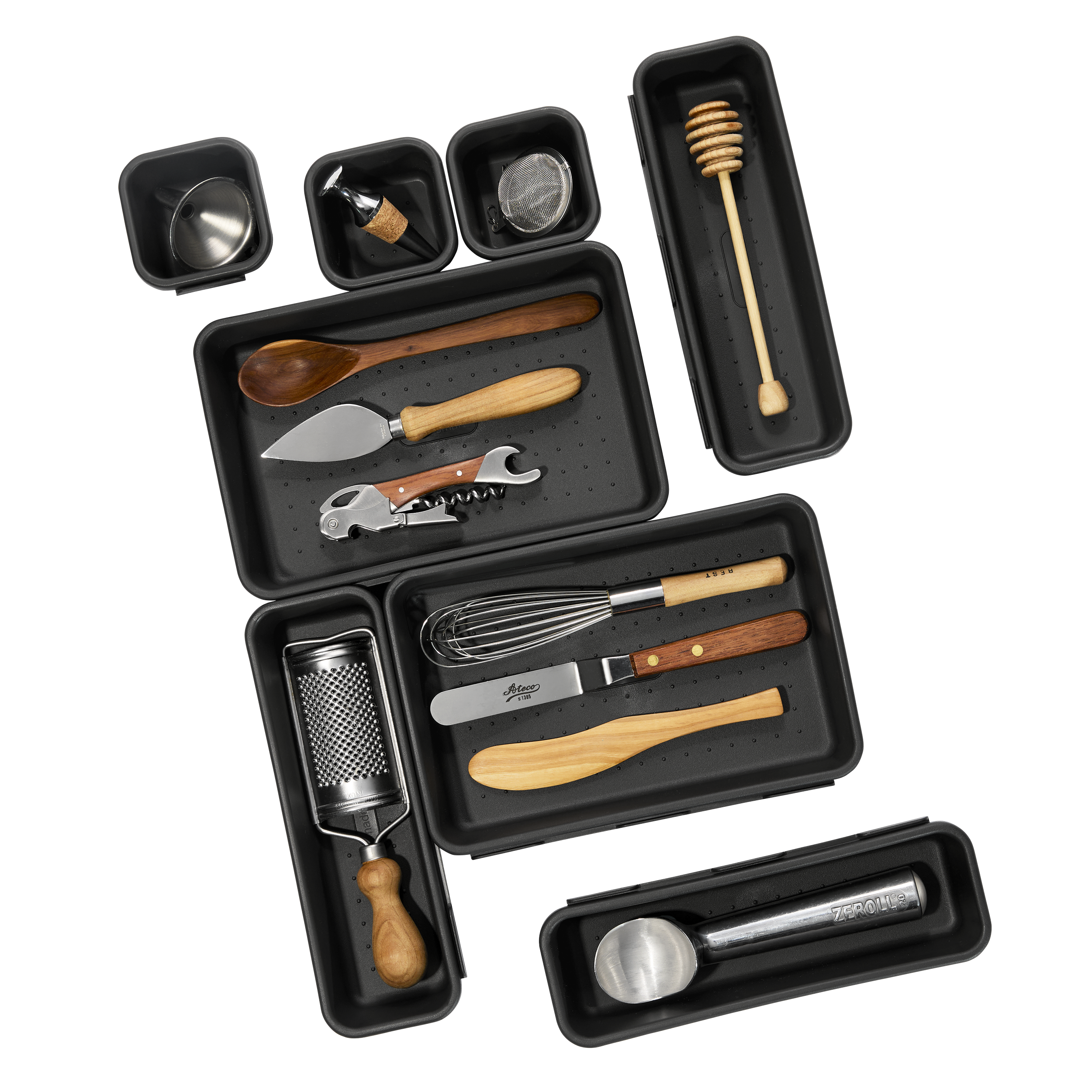 A collection of kitchen utensils and tools in black storage cases, including a wine opener, cheese grater, chef's knife, whisk, honey dipper, and various other utensils.