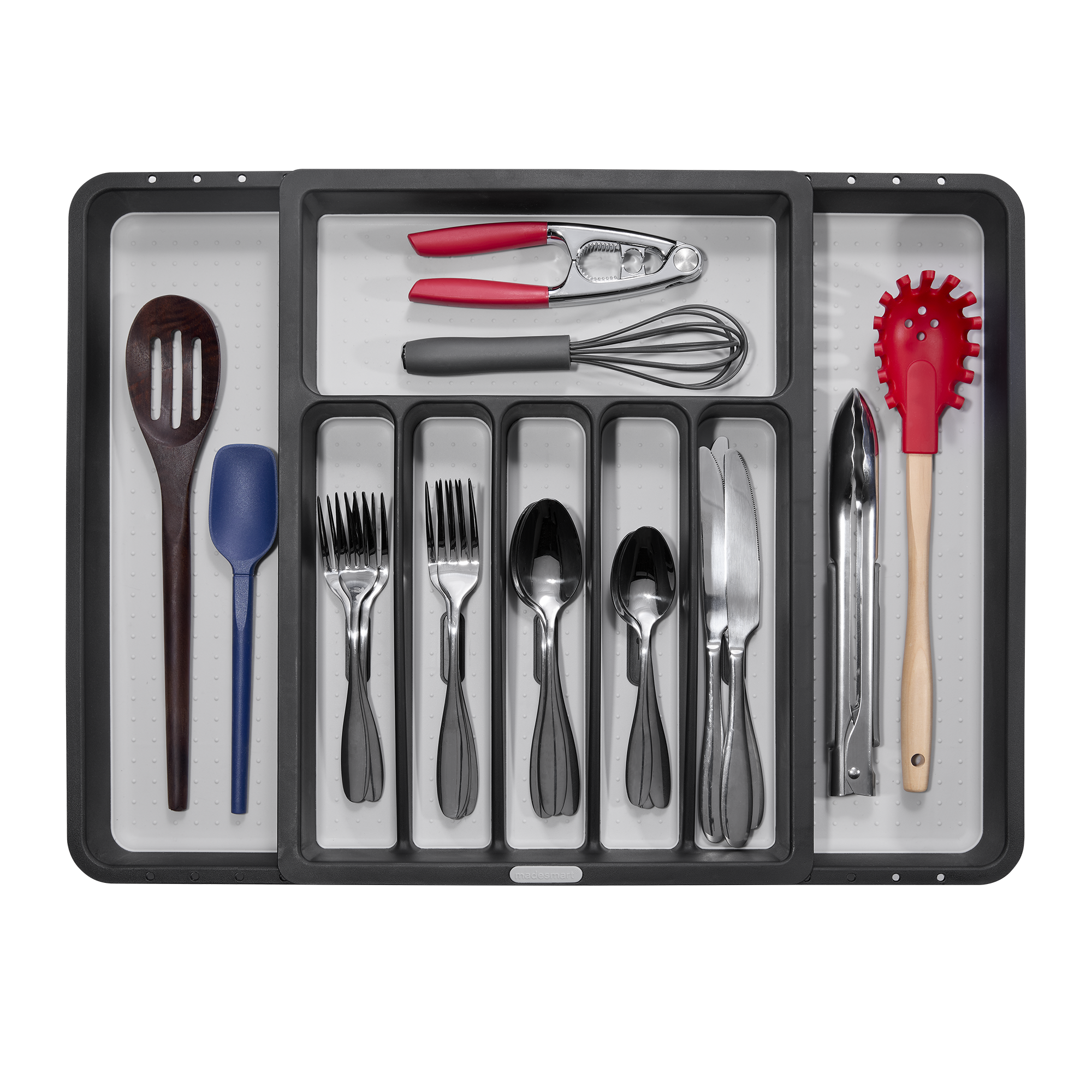 Kitchen utensil drawer containing spatulas, tongs, wine opener, whisks, forks, spoons, knives, and a slotted spoon.