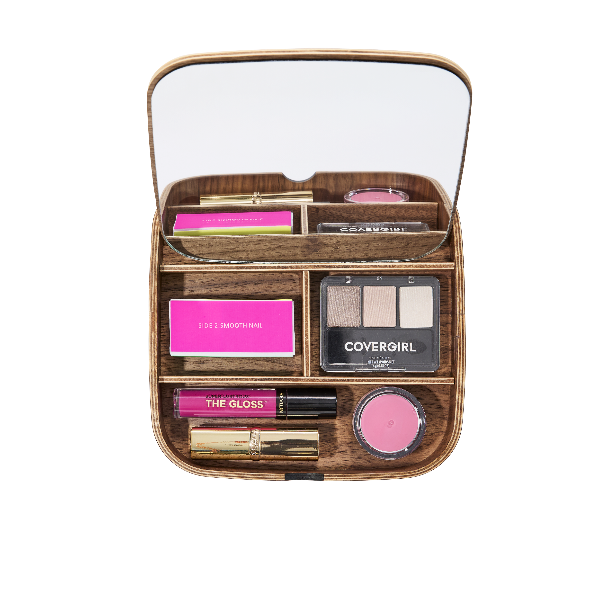 A wooden makeup organizer with a mirror on top, containing various makeup products including an eyeshadow palette, pink lipstick, pink lip gloss, blush, and skincare items.