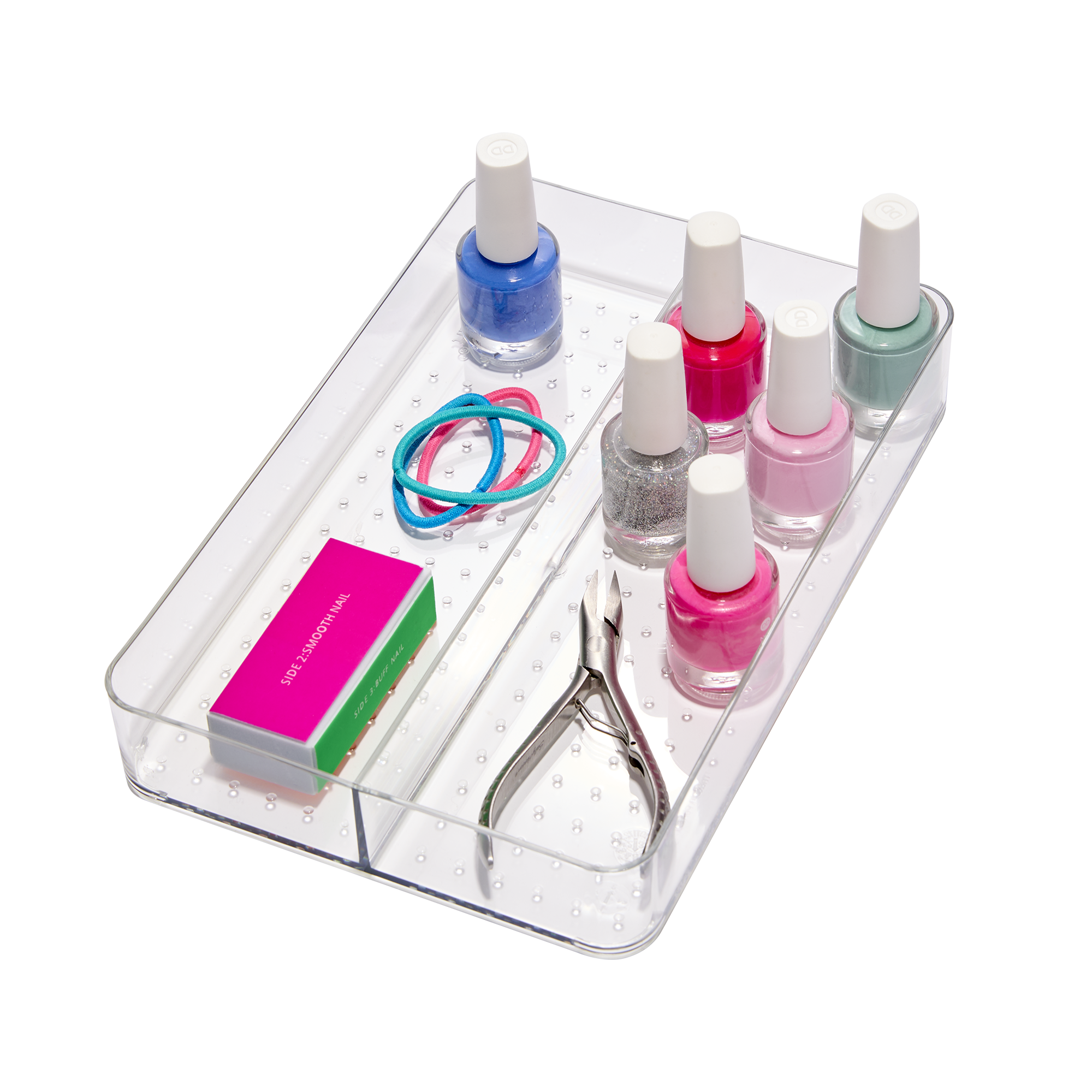 A clear plastic organizer tray holding various nail polish bottles, a small metal cuticle nipper, elastic hairbands, and a box of nail buffer files.