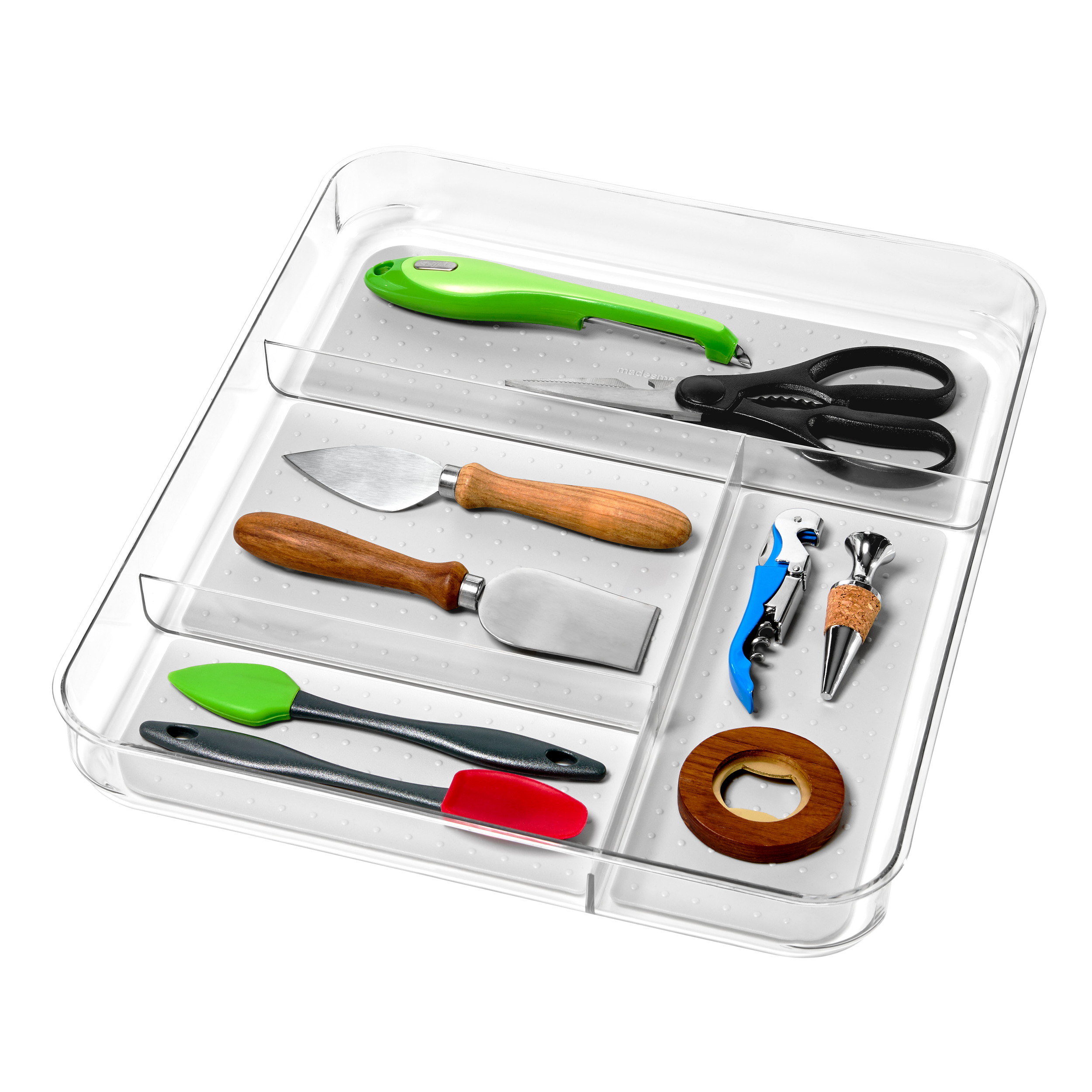 A plastic organizer box containing craft and kitchen tools including scissors, a craft knife, a small spatula, a mini chopper, a cookie cutter, a small scraper, reusable adhesive putty, and a wooden ring.