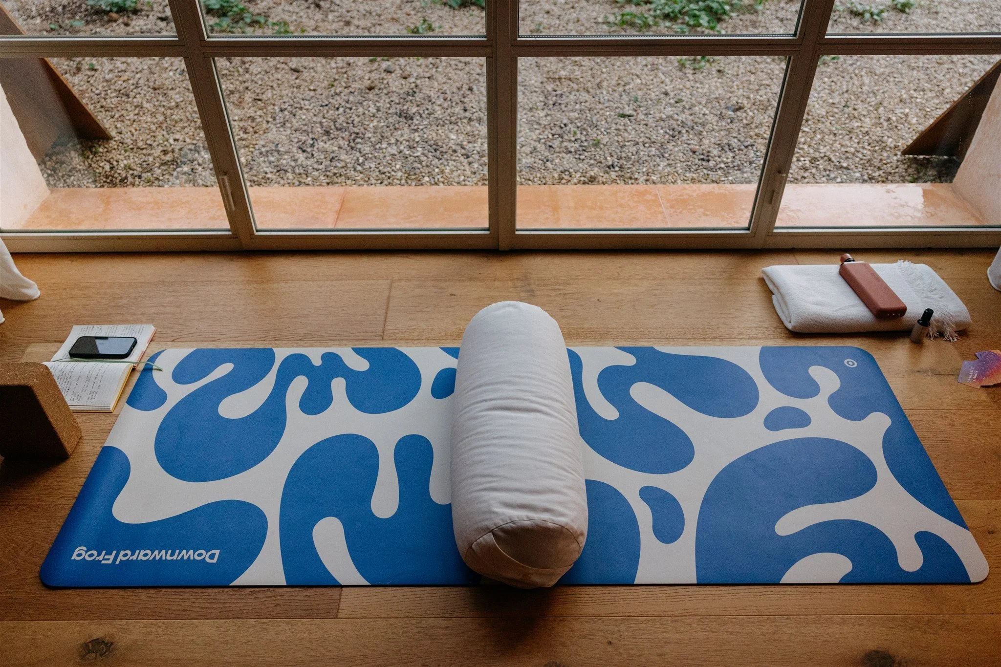 image of a blue and white yoga mat by a large window