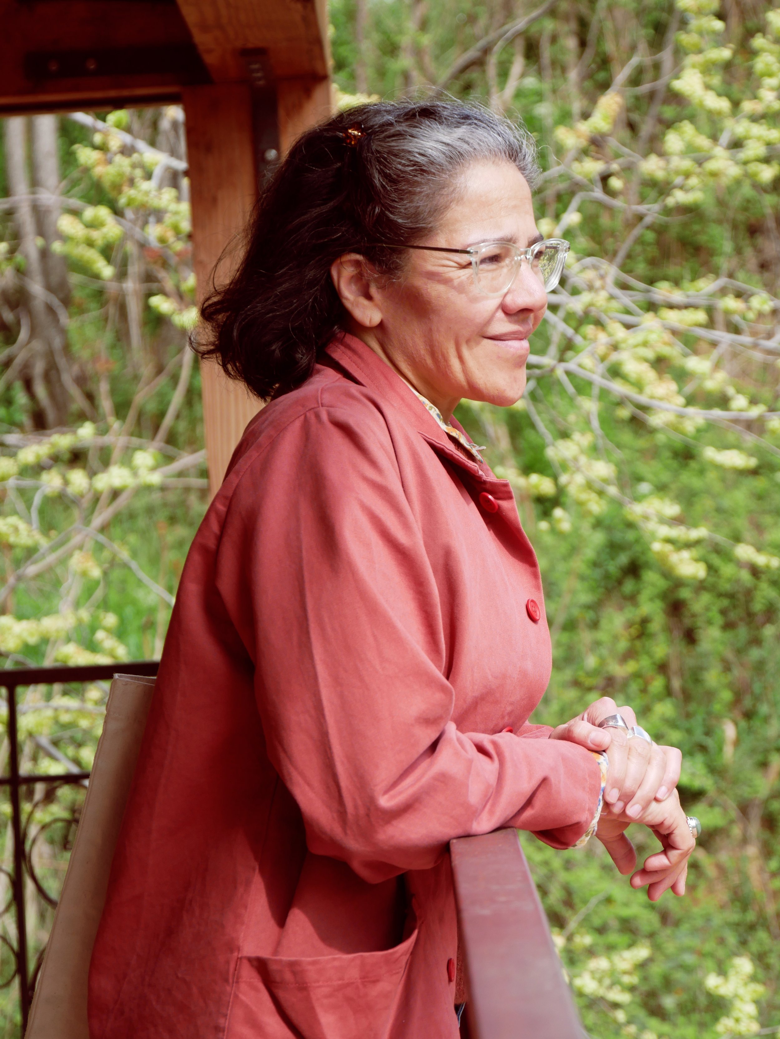 Woman, red jacket, glasses, side profile 