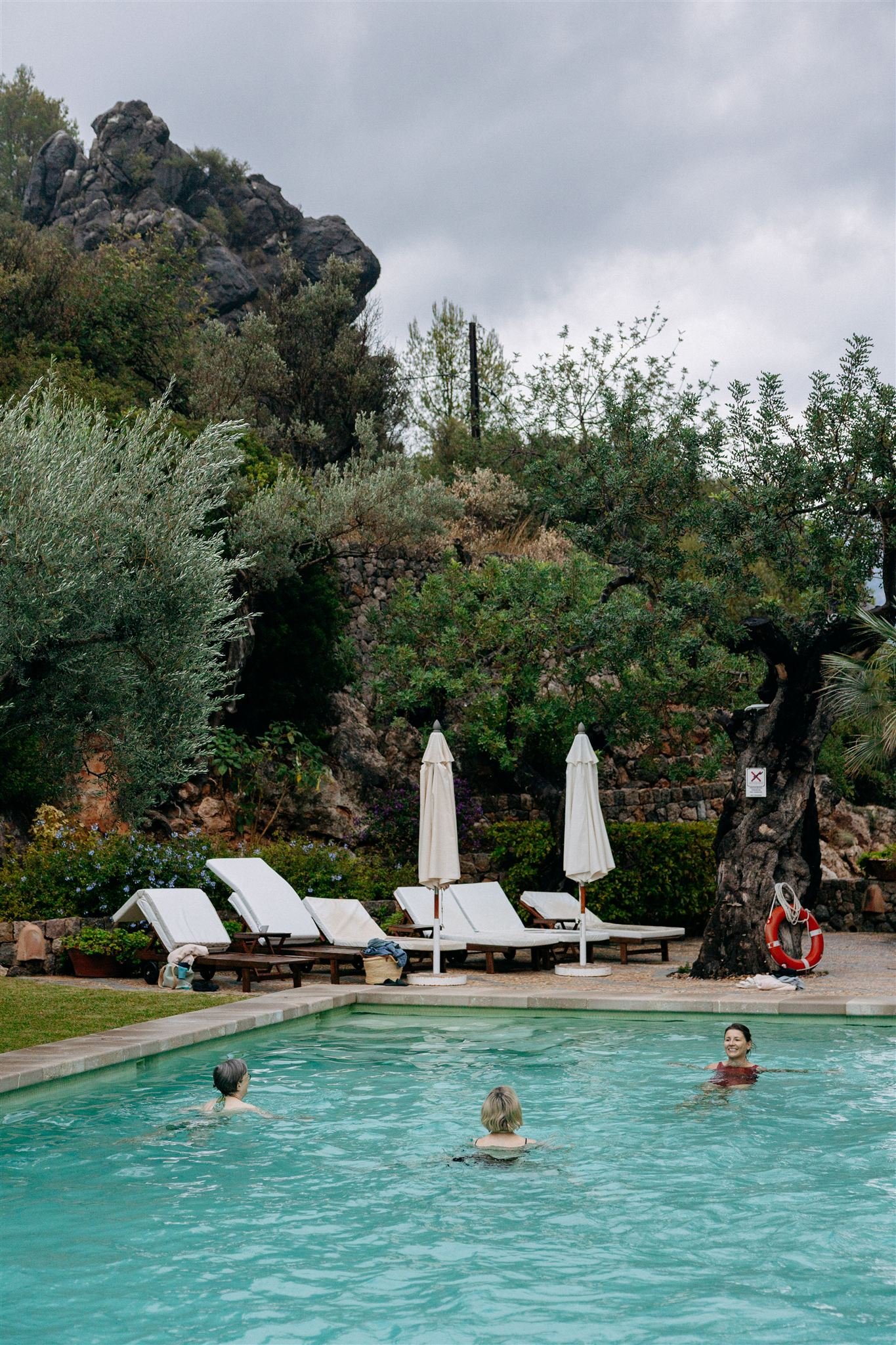 three women swimming in a pool
