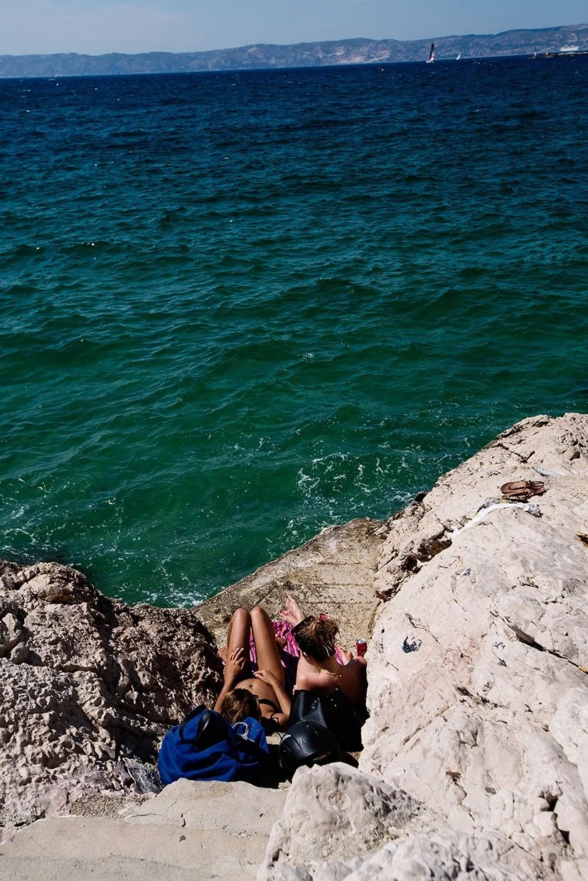 two women on the rocks chatting by the sea.jpeg