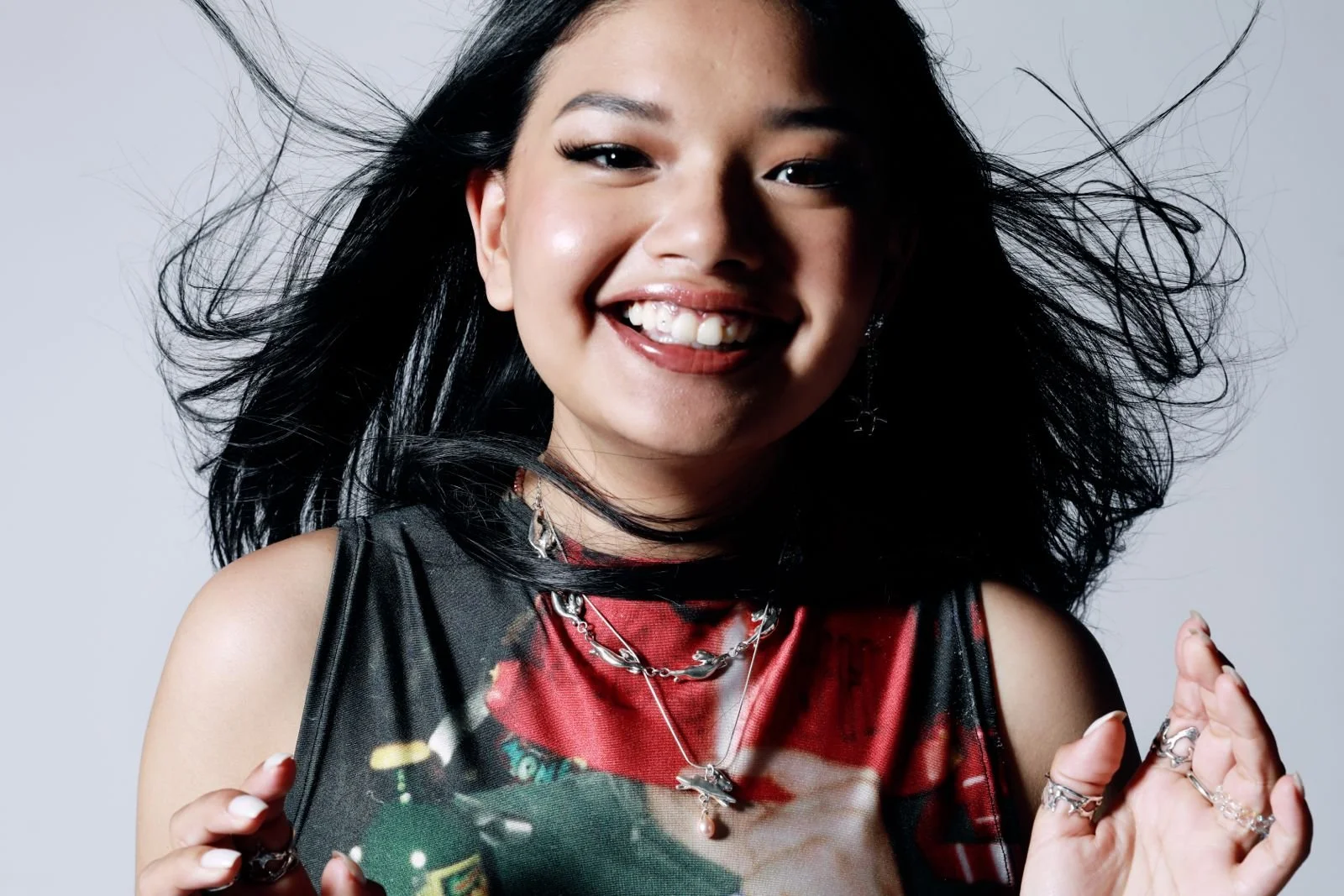 An image of artist Lucy Tun smiling at the camera.