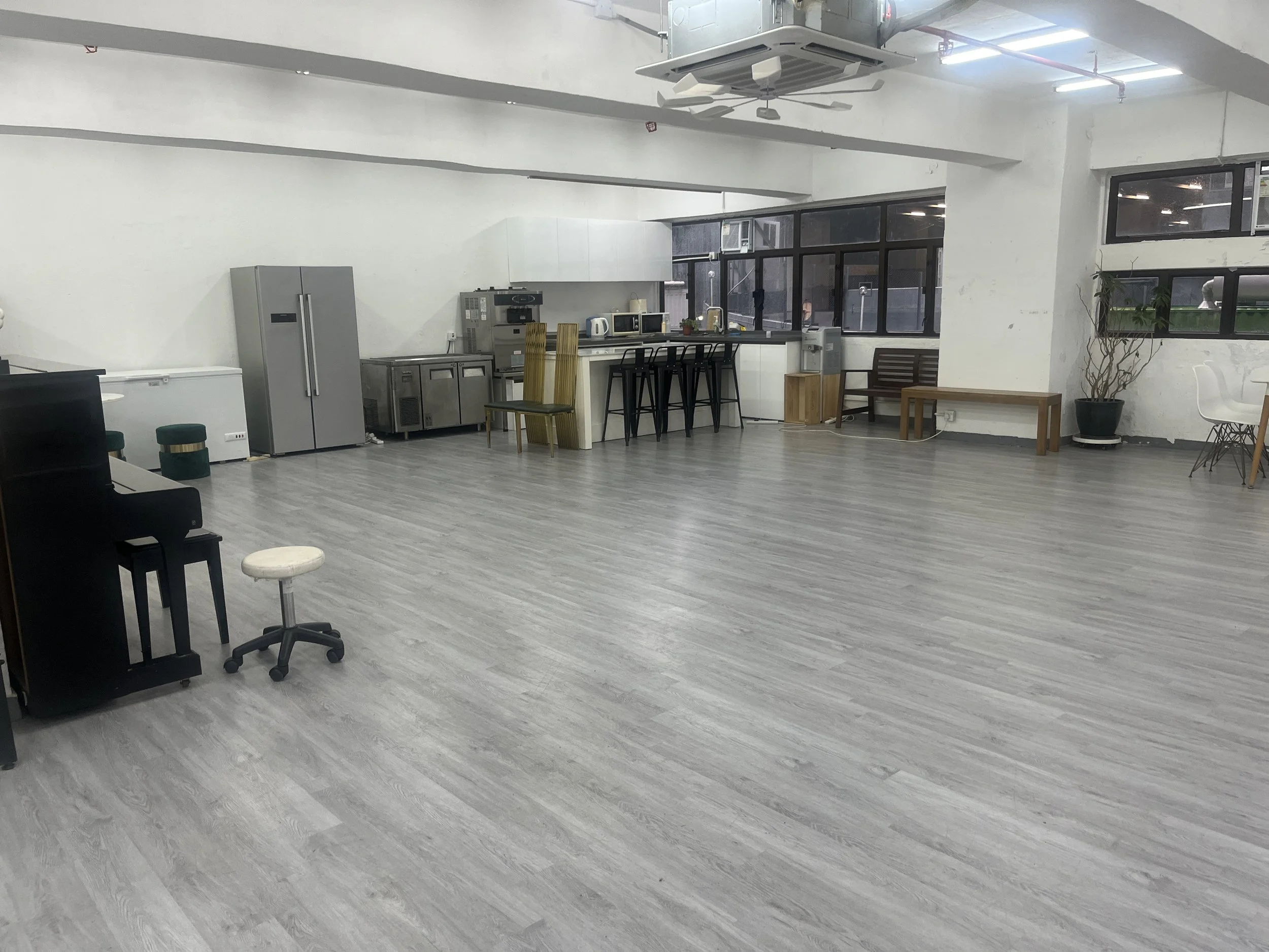 An open kitchen counter studio equipped with bar stools and double refrigerators for private catered functions in Wong Chuk Hang.