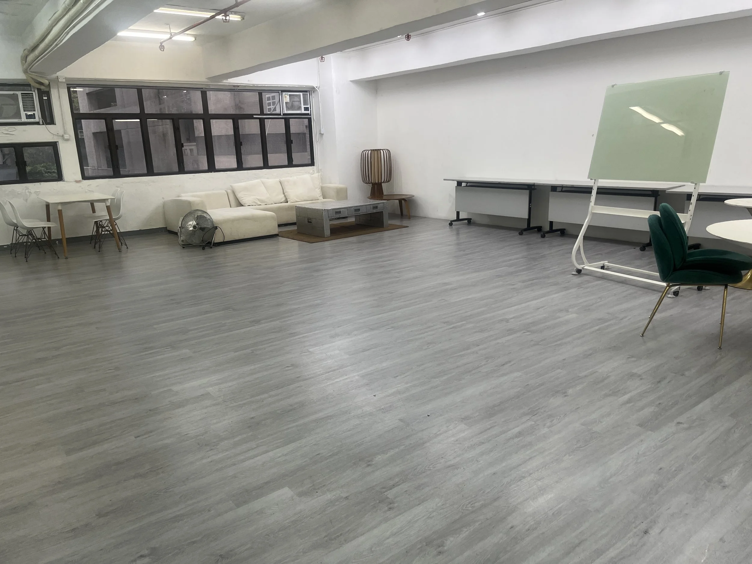In-house event setup equipment showing a clean stainless steel refrigerator, white board, and mobile presentation gear.