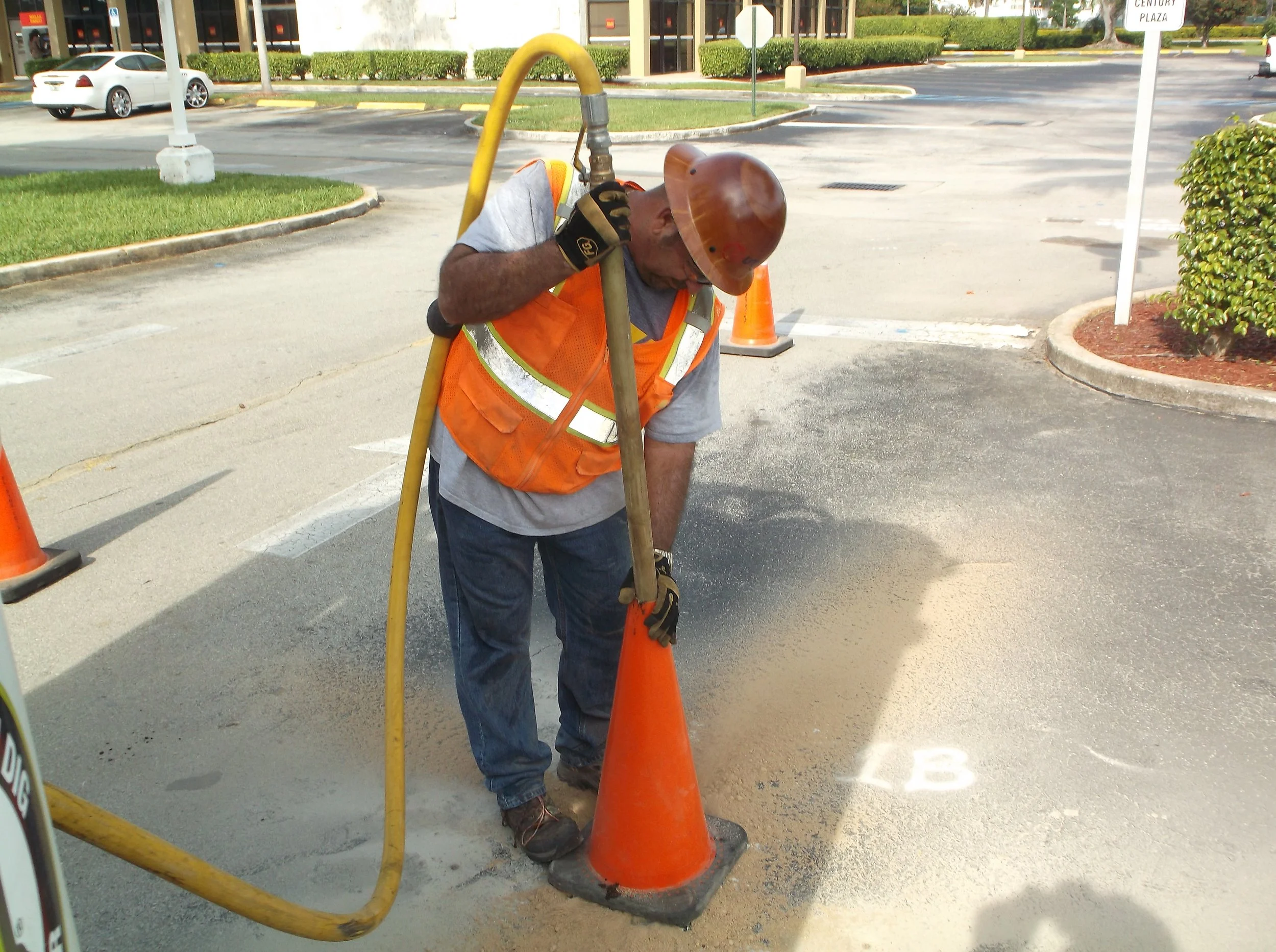 Vacuum truck performing air excavation for private utility locating.