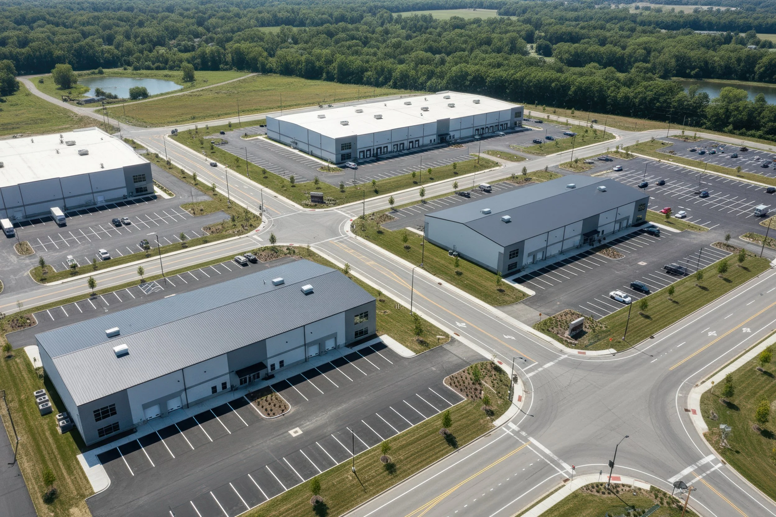 Photo-real concept for Stonecrest Business Park in New Beaver, PA: multiple light-industrial/flex buildings, internal loop road, truck courts, striped parking, and landscaped stormwater ponds with direct PA-18 access—showing build-to-suit potential.