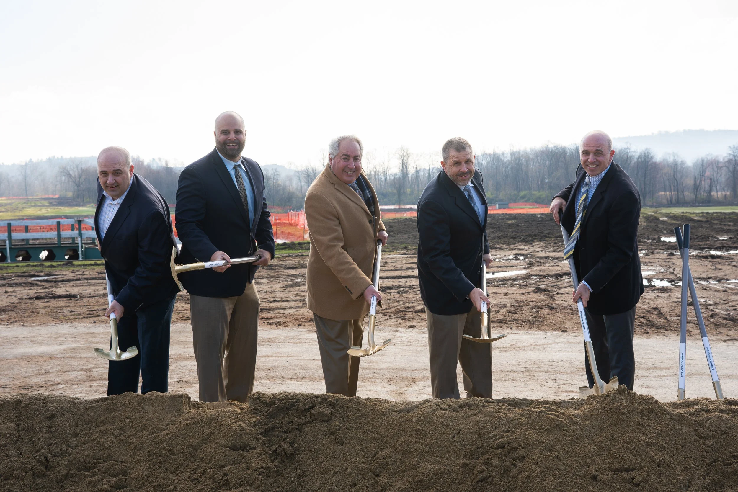 Dan LaCarte, John LaCarte, Joe LaCarte, Mike LaCarte, and Dave LaCarte breaking ground with shovels at Stone Crest Business Park, captured by Ian Jones in Pittsburgh, Pennsylvania