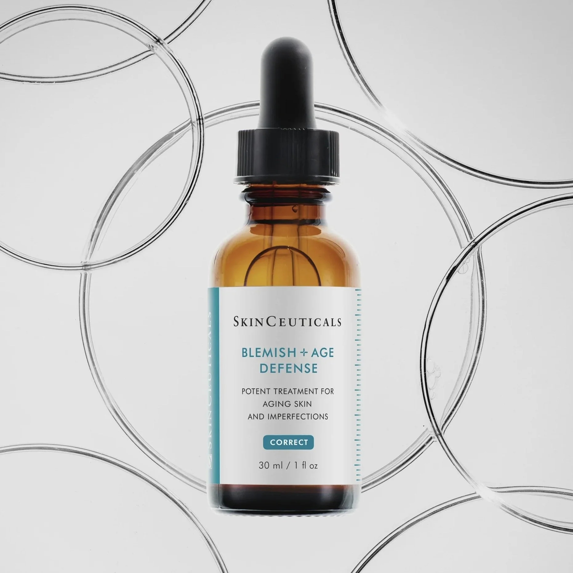 A brown glass dropper bottle labeled 'SkinCeuticals Blemish + Age Defense' surrounded by several clear glass petri dishes on a white background.